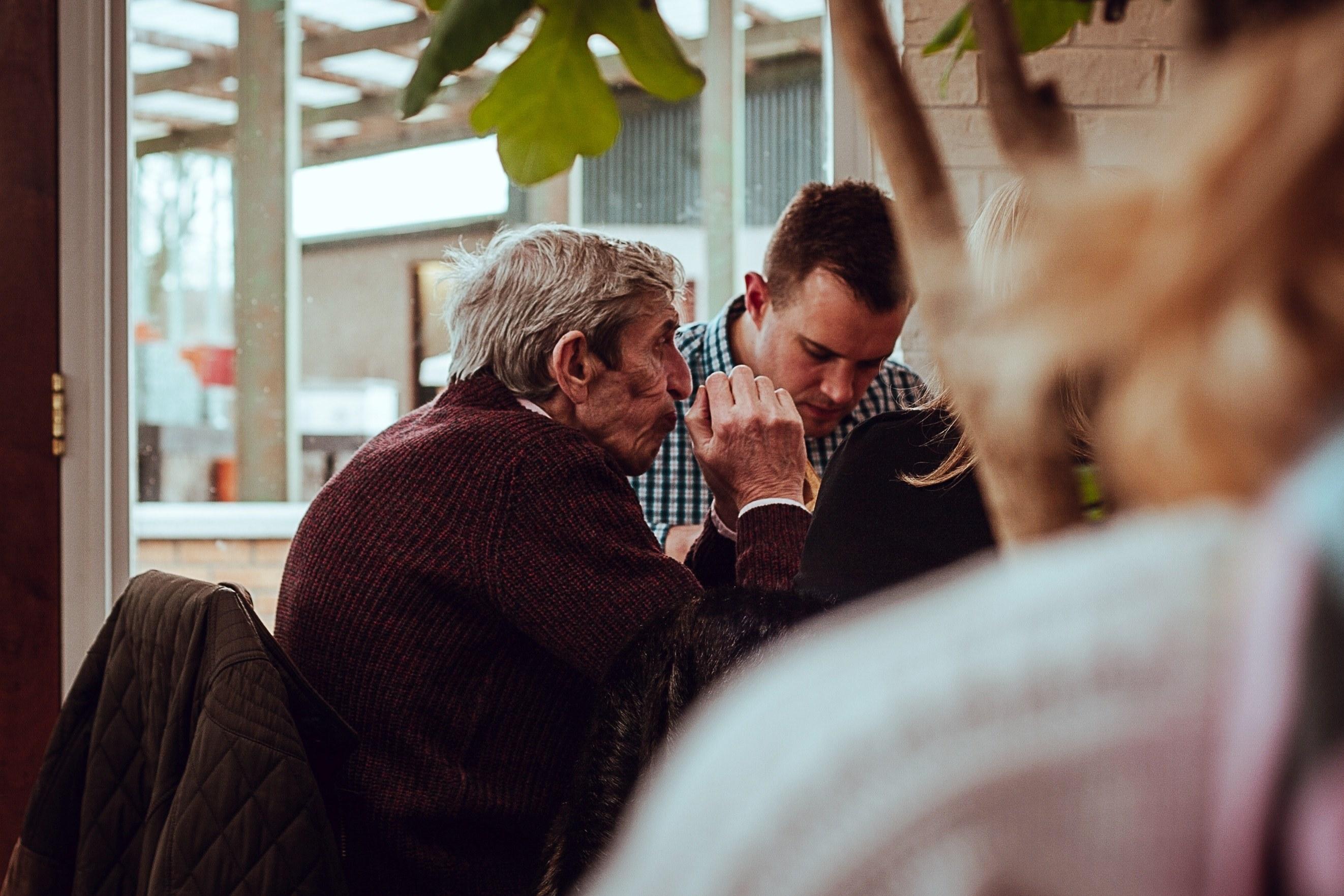 2644x1763 Wallpaper / an old man with gray hair wearing a sweater sitting with a young man in stanfield, _a moment 4k wallpaper