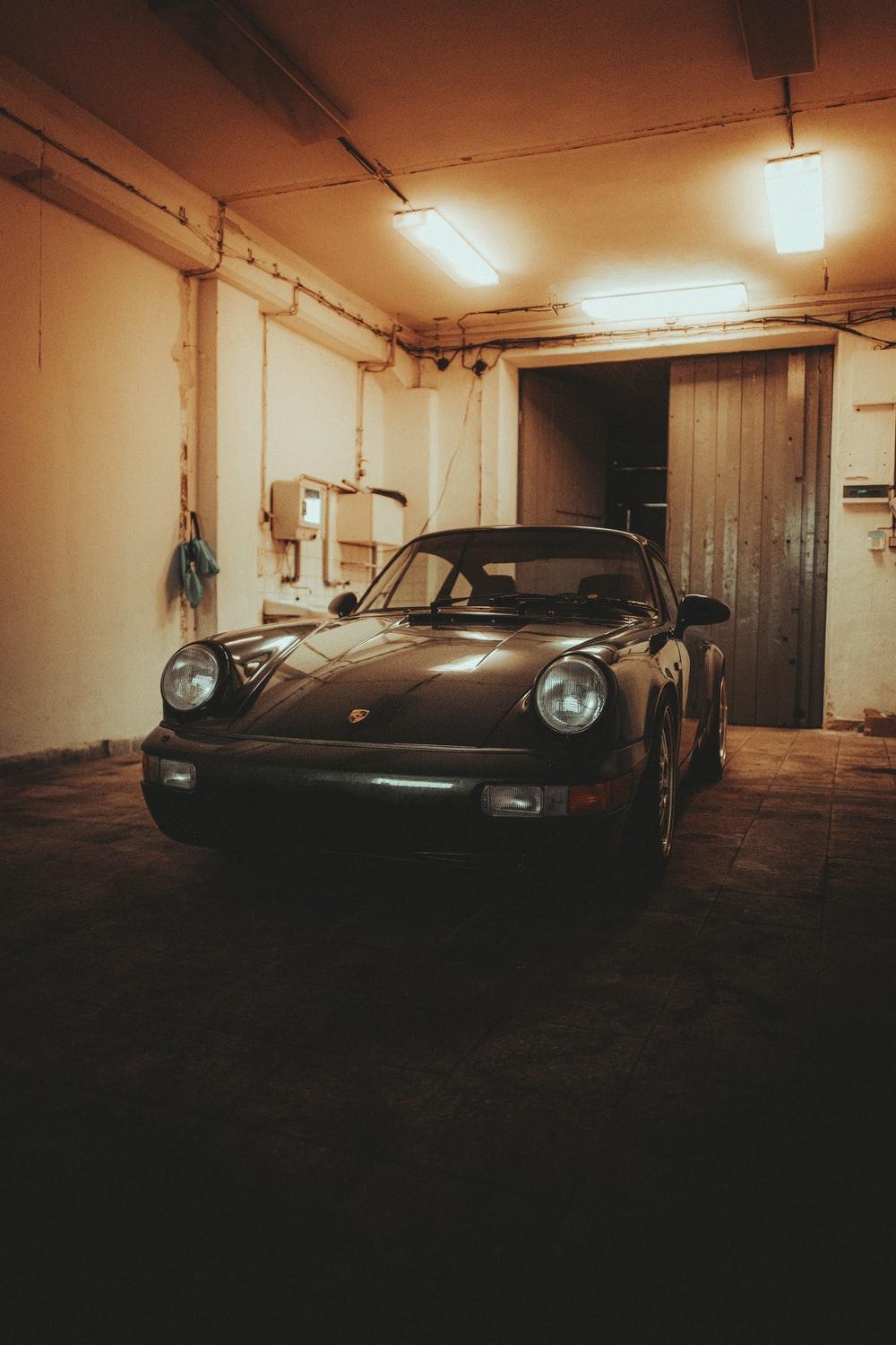 1000x1500 black porsche 911 parked in garage photo