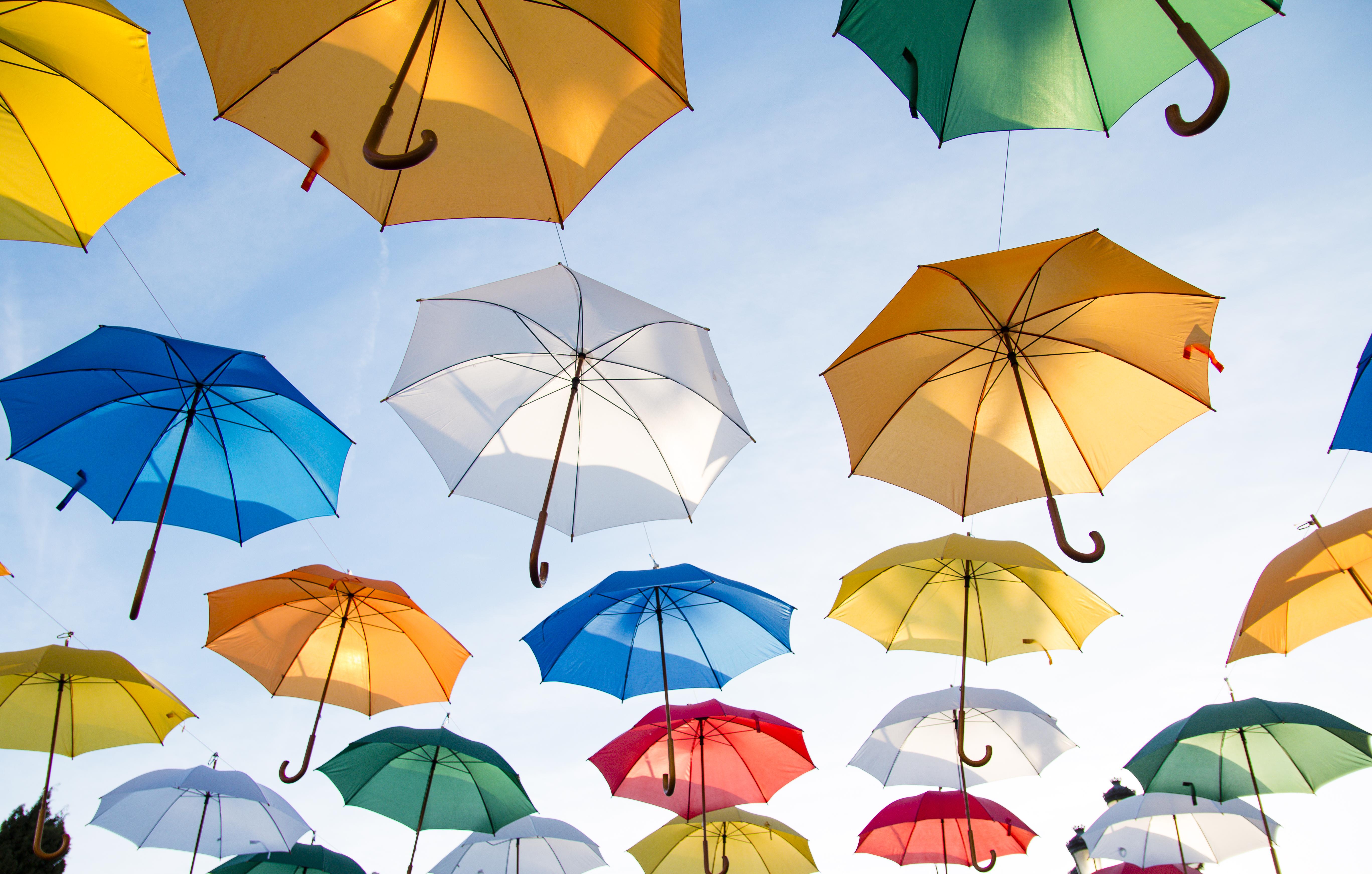 5472x3485 Assorted Color Straight Umbrella Hanging On Black Wire · Free