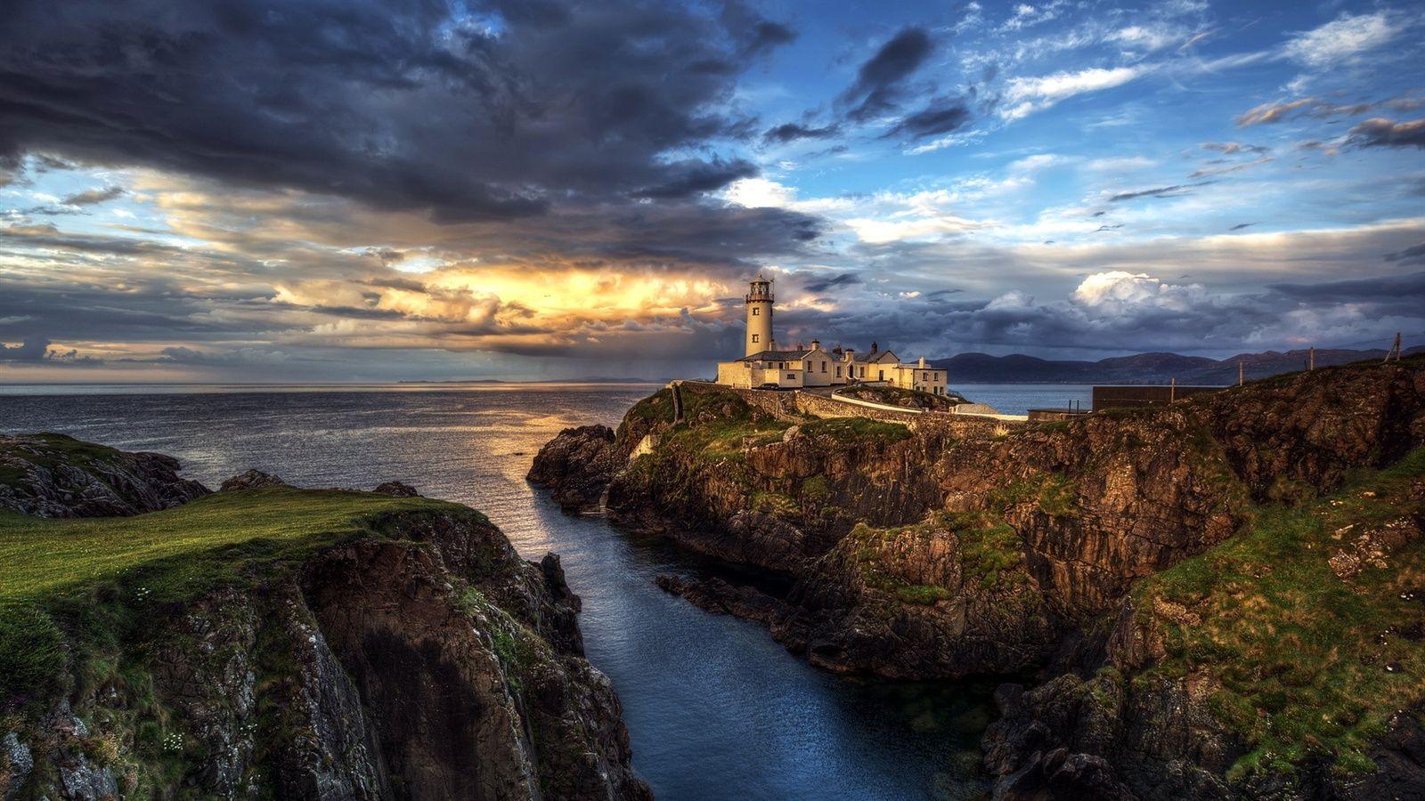 1600x900 Ireland, lighthouse, ocean, seascape, sunset, clouds wallpaper