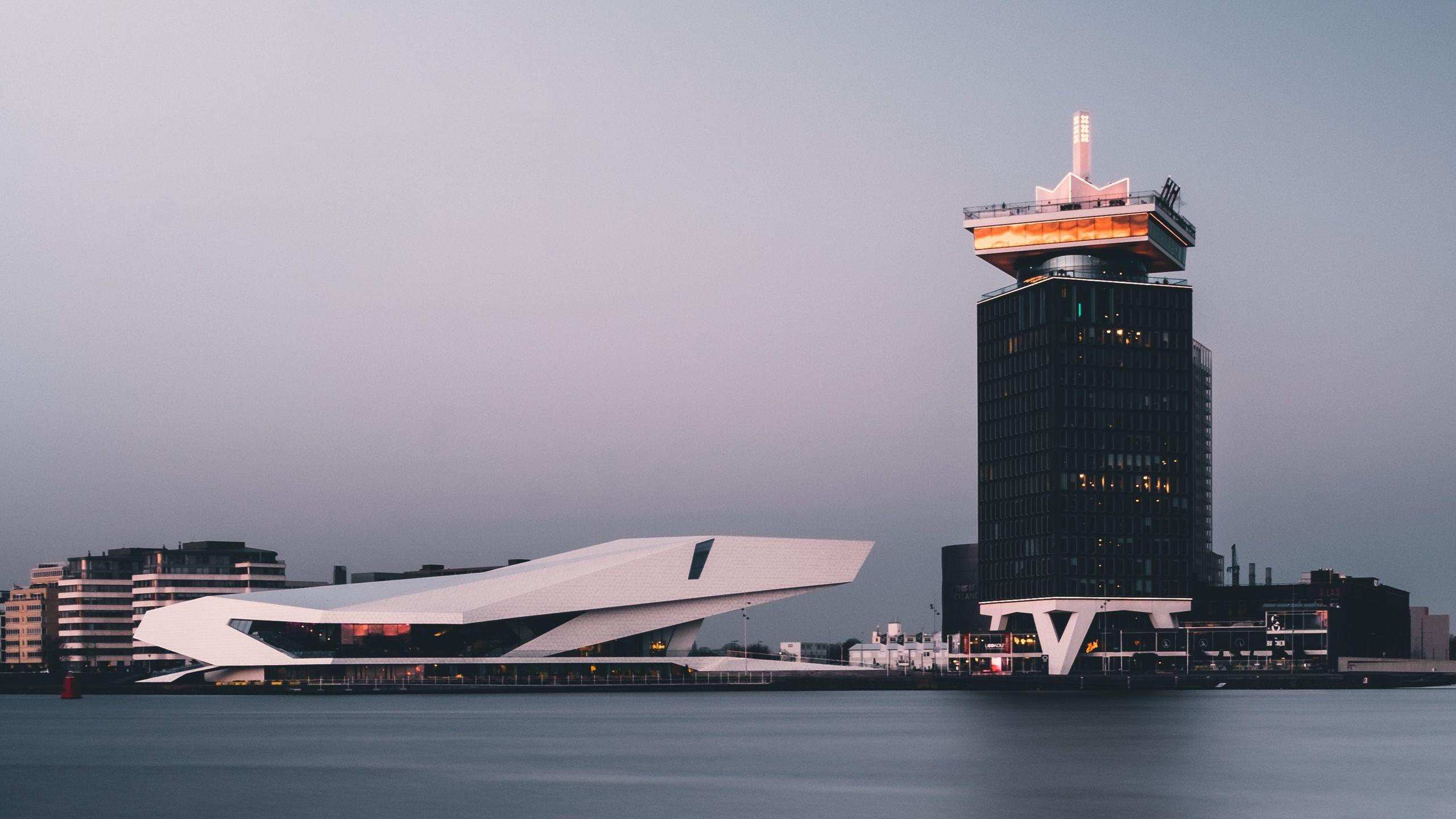 2560x1440 Download wallpaper 2560x1440 amsterdam, netherlands, building, shore widescreen 16:9 HD background