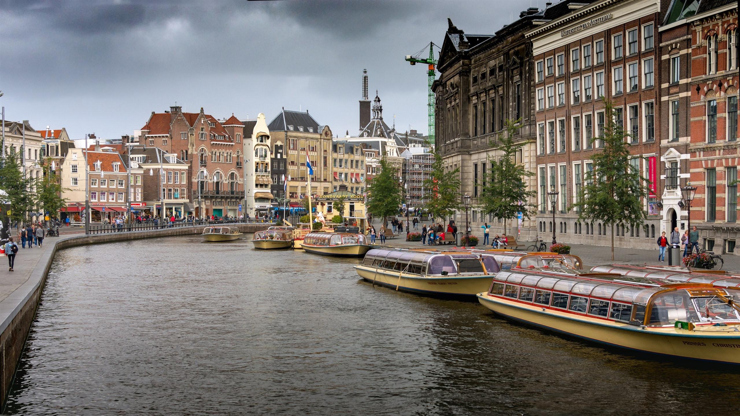 2560x1440 Wallpaper Amsterdam, Netherlands, city, river, boats, houses, clouds 2880x1800 HD Picture, Image