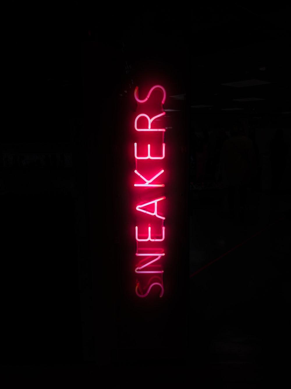 1000x1333 turned on red sneakers neon light in dark place photo