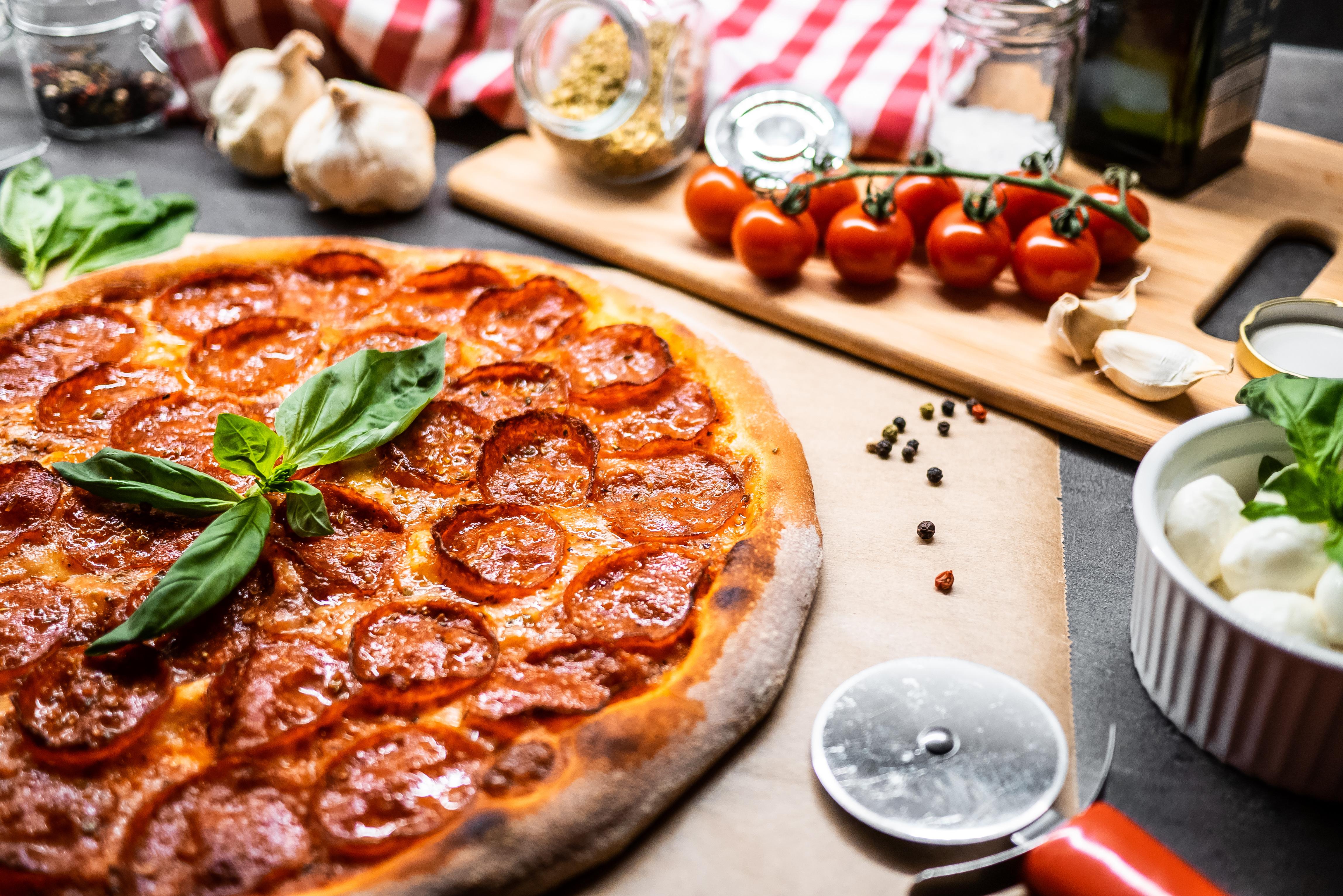 4592x3064 Pepperoni pizza on the table with vegetables and spices wallpaper and image, picture, photo