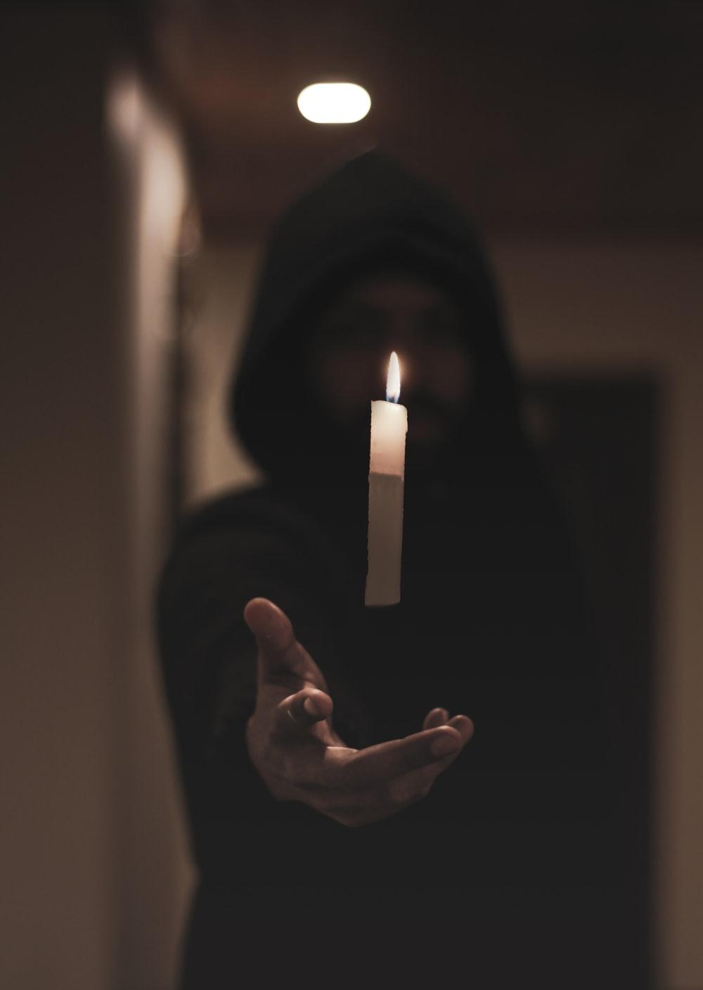 1000x1409 floating lit candle stick photo