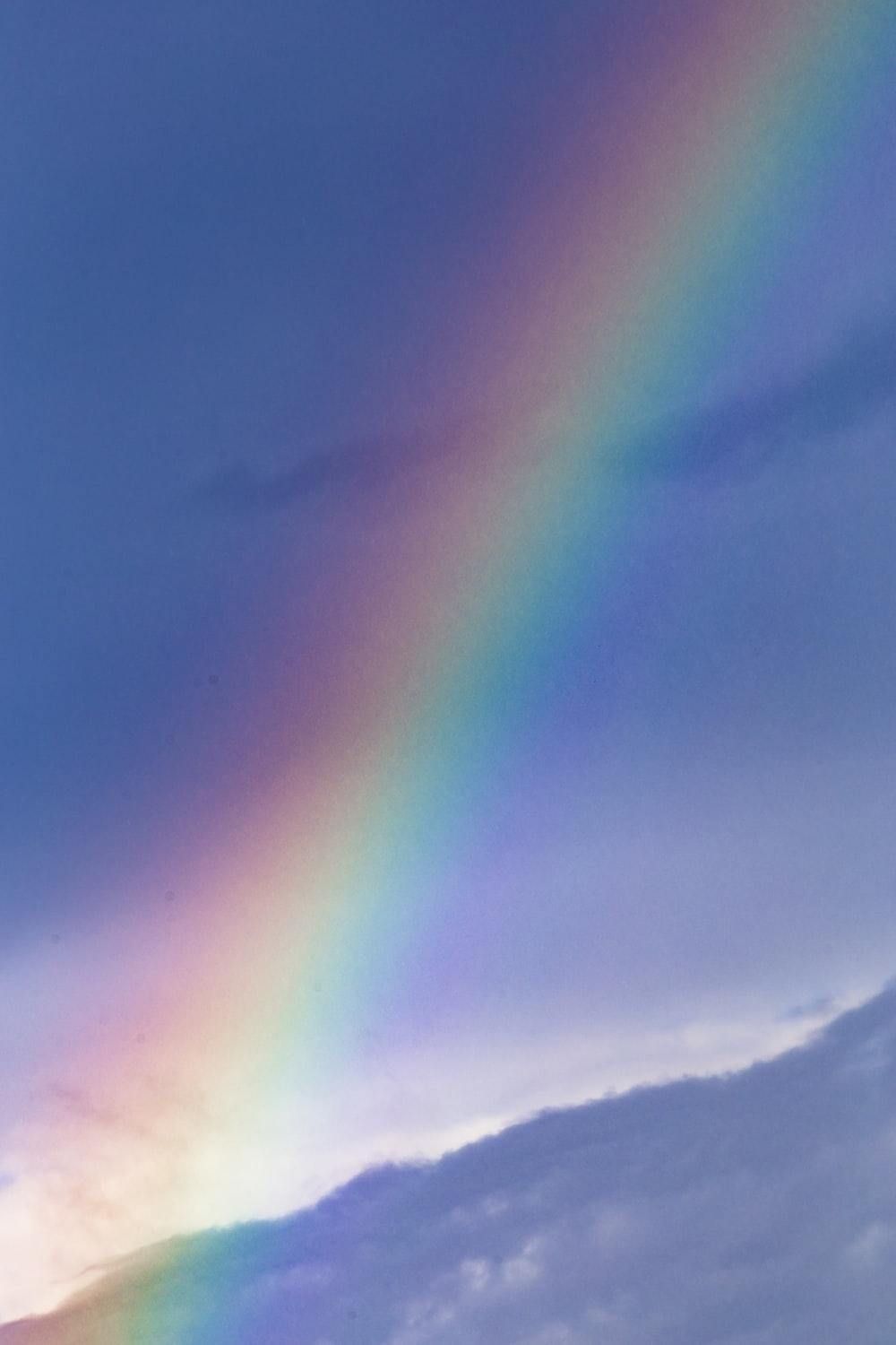 1000x1500 rainbow over the clouds during daytime photo