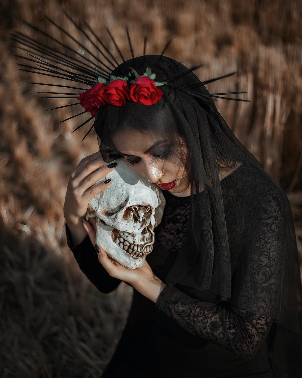 1000x1250 woman in black long sleeve shirt holding white skull photo