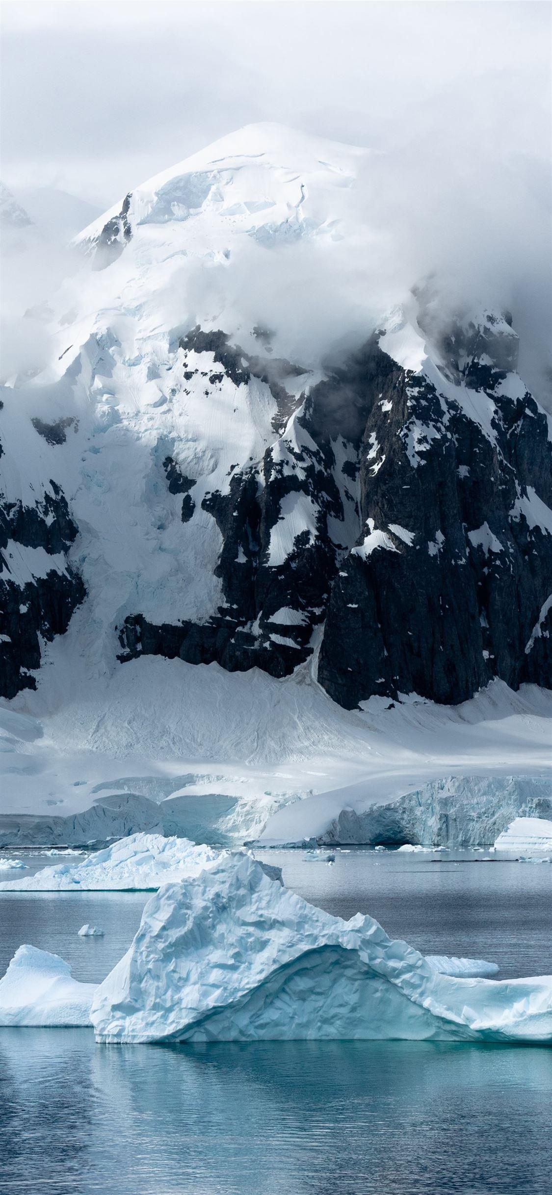 1125x2436 small iceberg beside large iceberg iPhone X Wallpaper Free Download