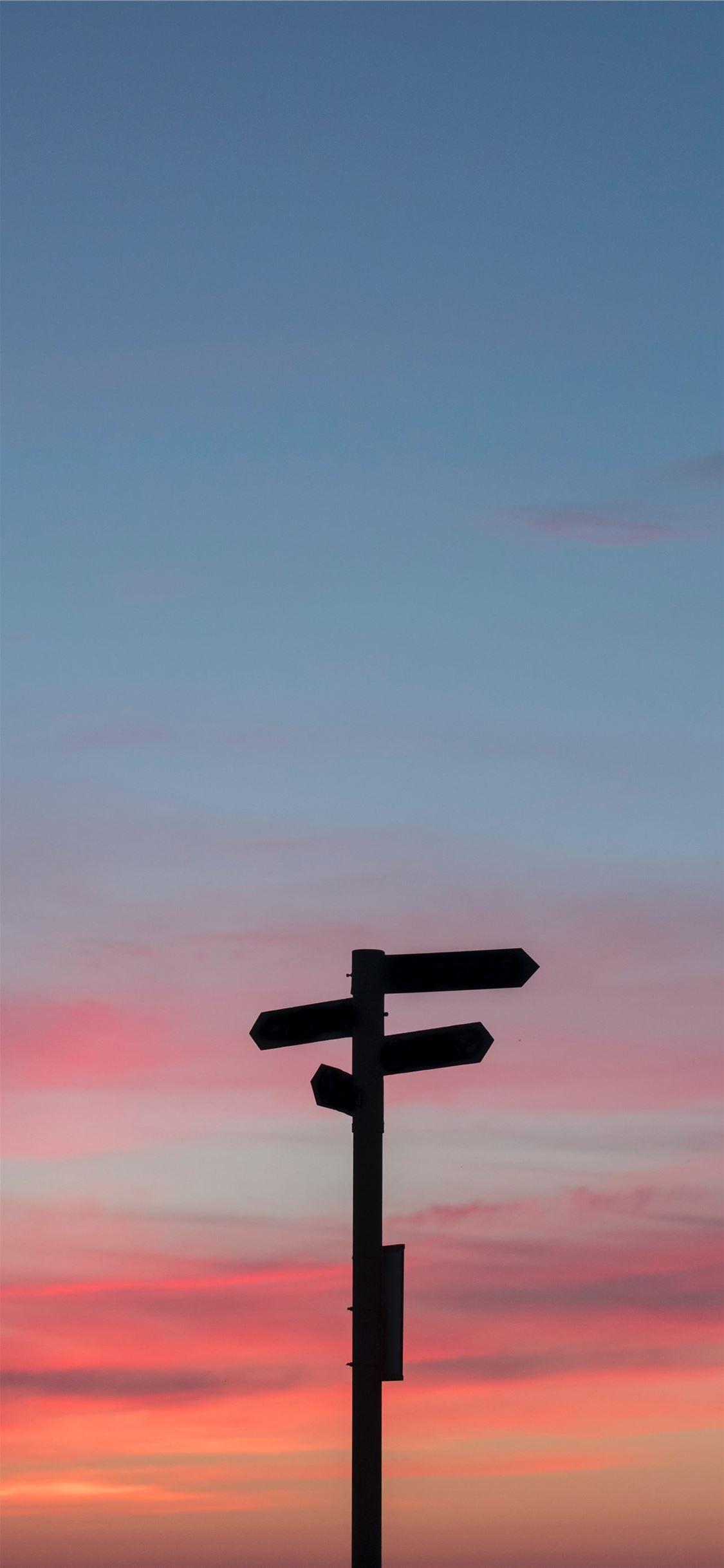 1125x2436 silhouette of a road signage during golden hour iPhone X Wallpaper Free Download