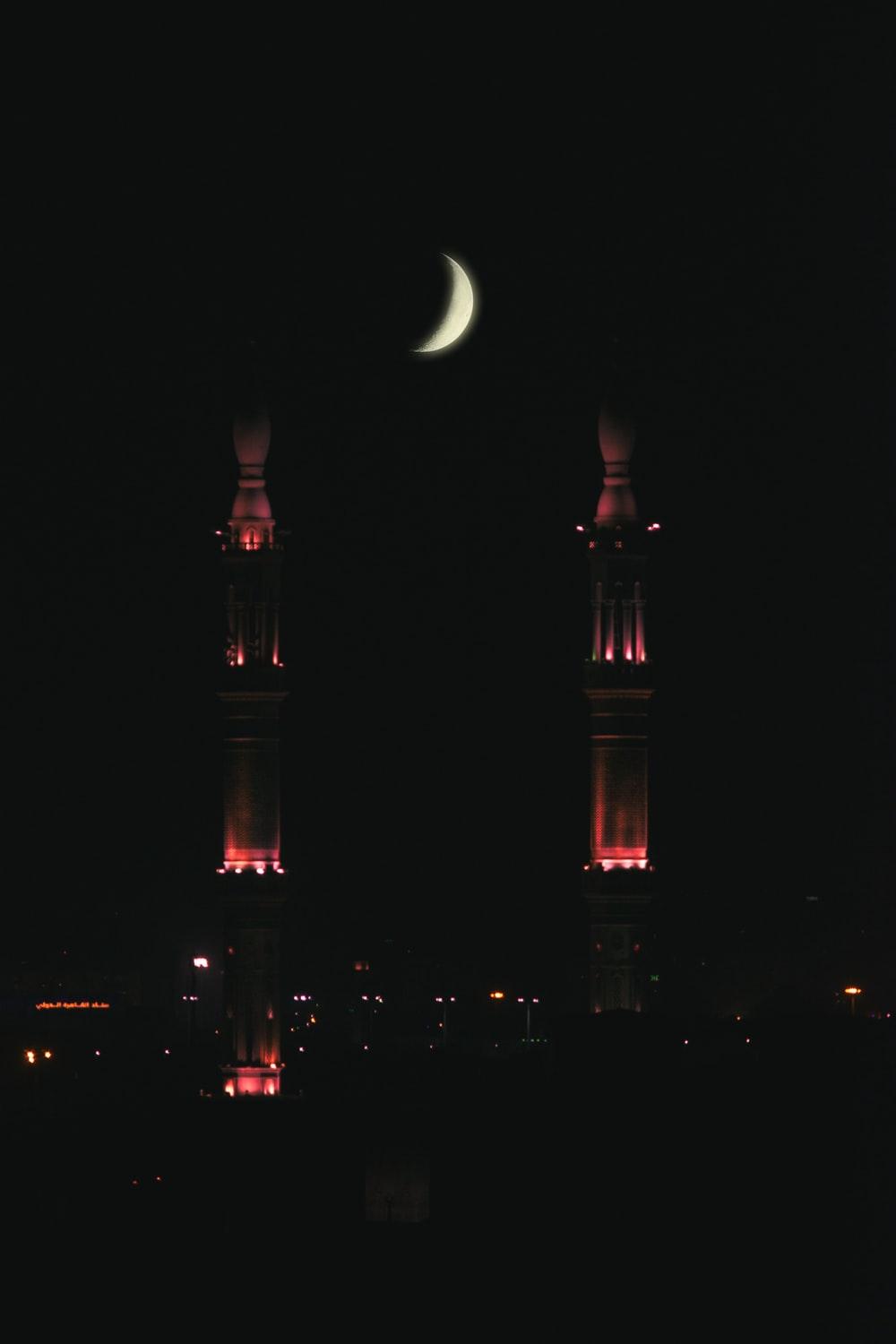 1000x1500 crescent moon above buildings lighted at night photo