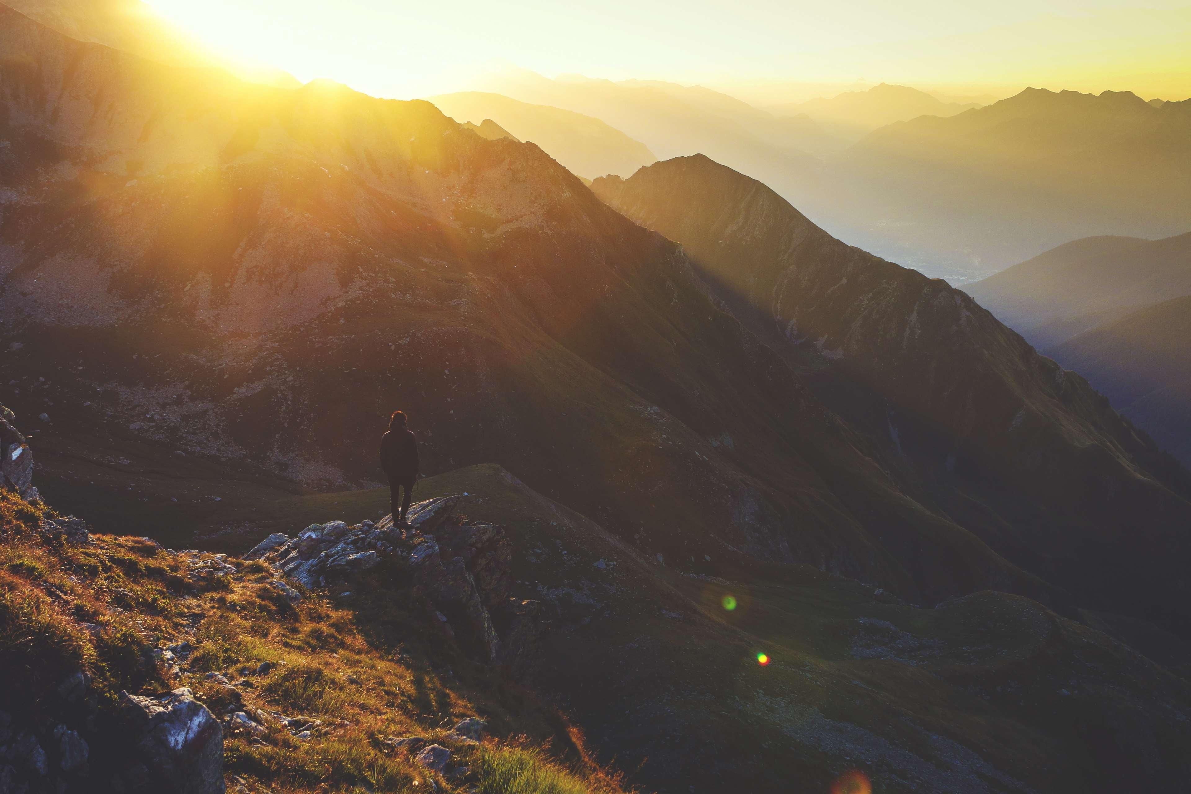 3840x2560 early, morning, mountain range, mountains, person, rocky, solo, sun, sun glare, sunrise, valley 4k wallpaper