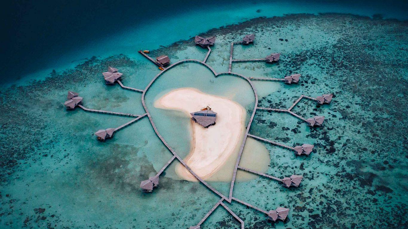 1366x768 Download wallpaper 1366x768 island, heart, aerial view, bungalow, ocean tablet, laptop HD background