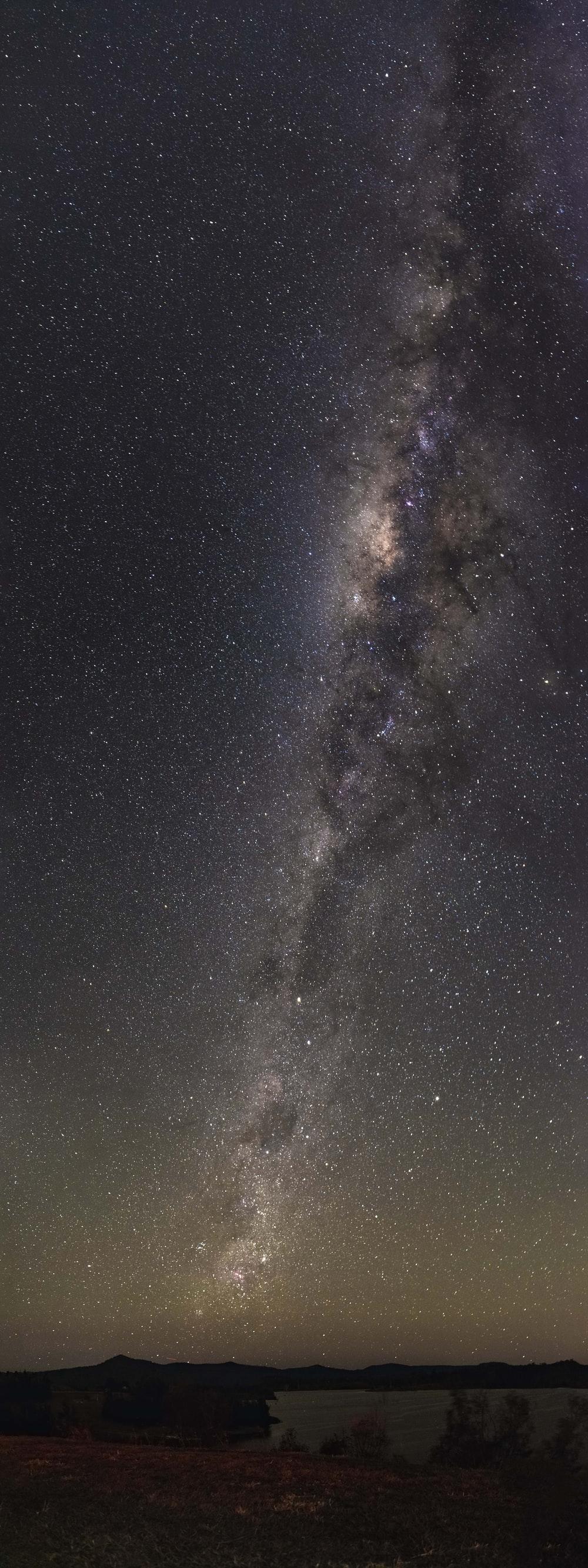 1000x2666 body of water under starry night photo
