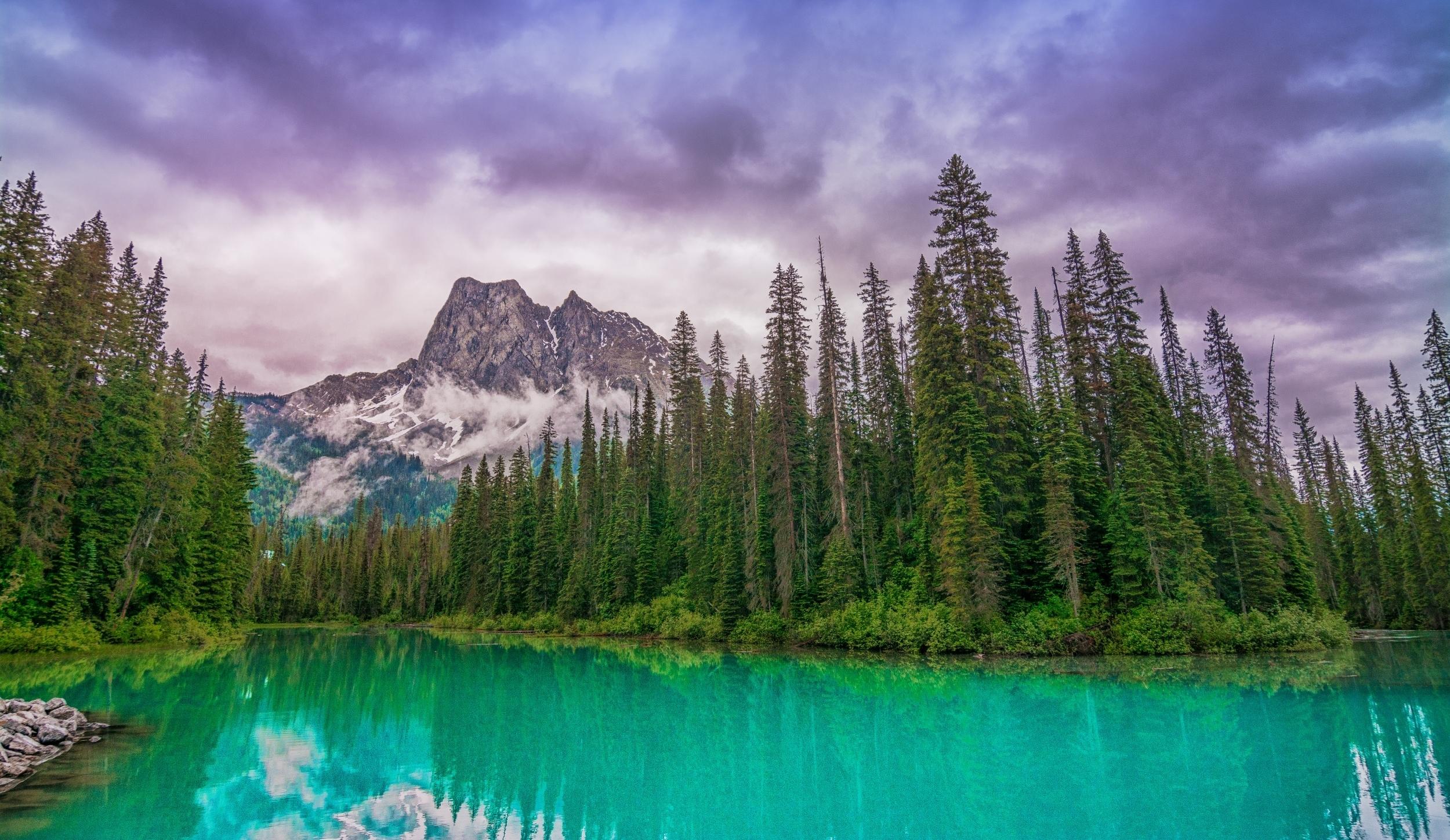 2500x1449 lake, turquoise, trees, snowy peaks, beautiful, forest, Dark Clouds, green, mountain wallpaper