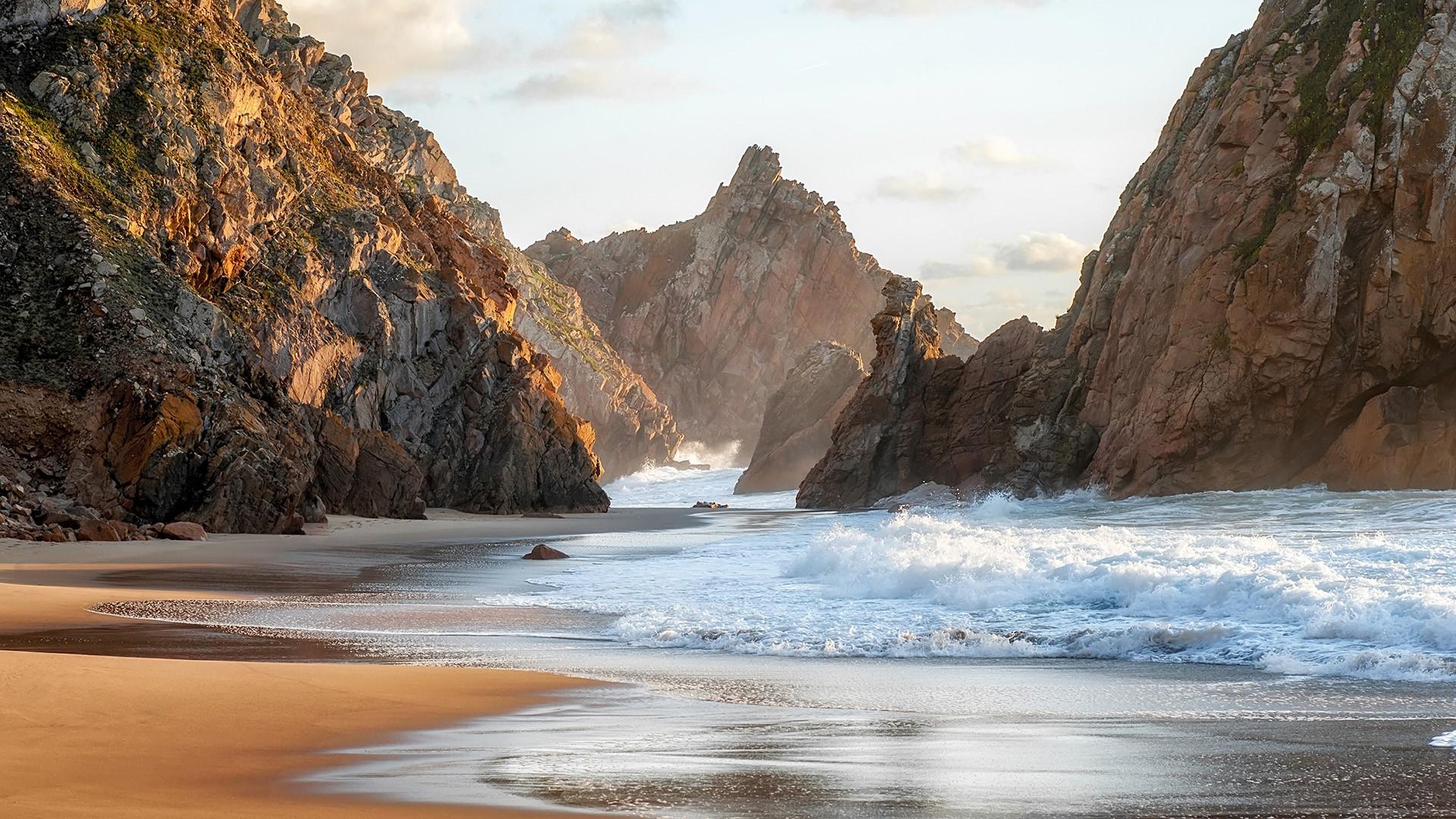 1920x1080 Sandy Atlantic ocean beach at sunset, Sintra, Portugal. Windows 10 Spotlight Image
