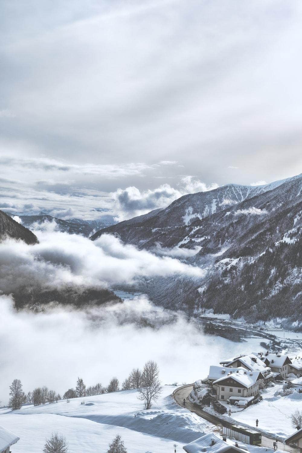 1000x1500 Snow Covered Village Near Mountains Under White Clouds During Daytime Photo