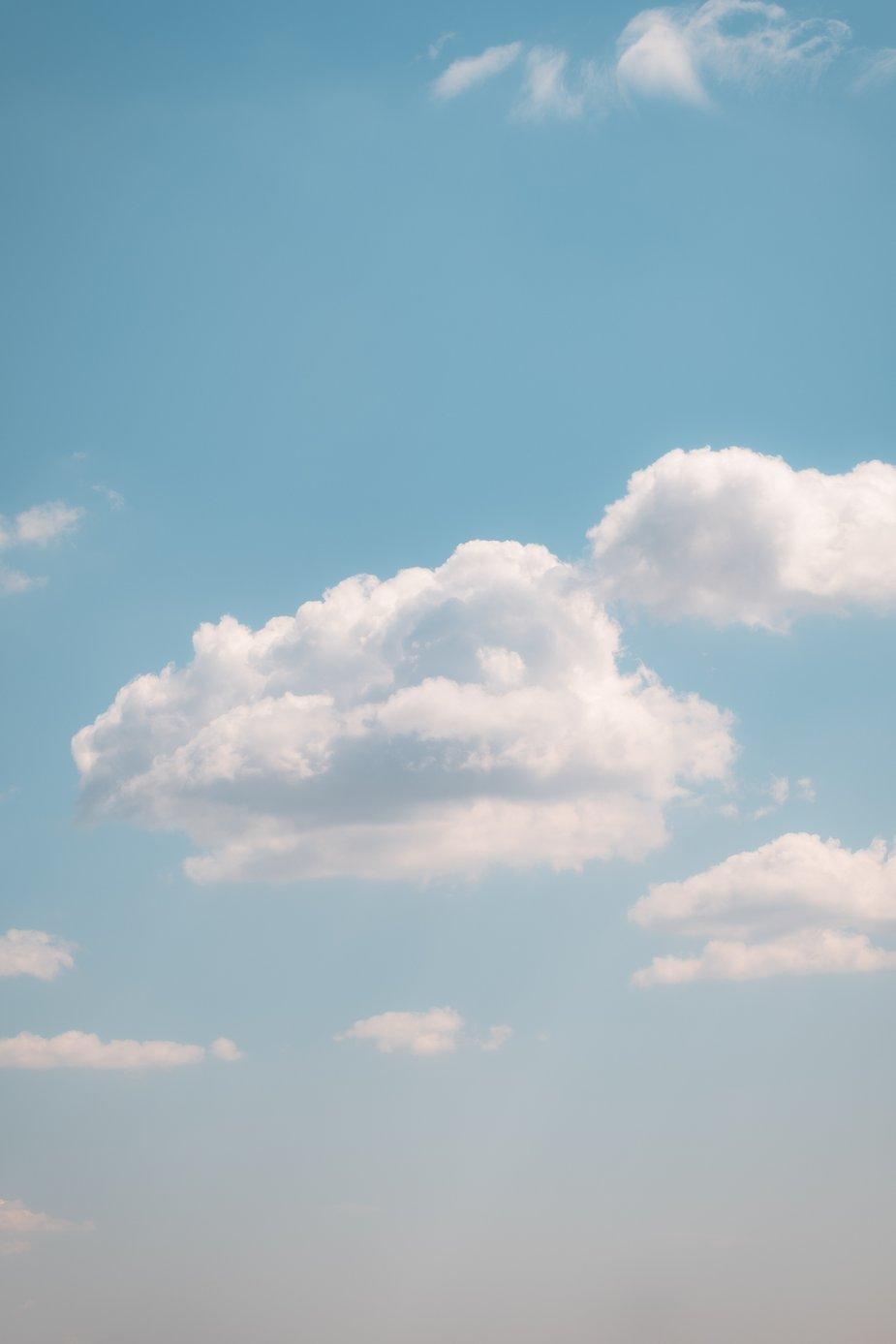 925x1387 Browse Free HD Image of Fluffy Clouds In A Light Blue Sky On A Clear Summer Day