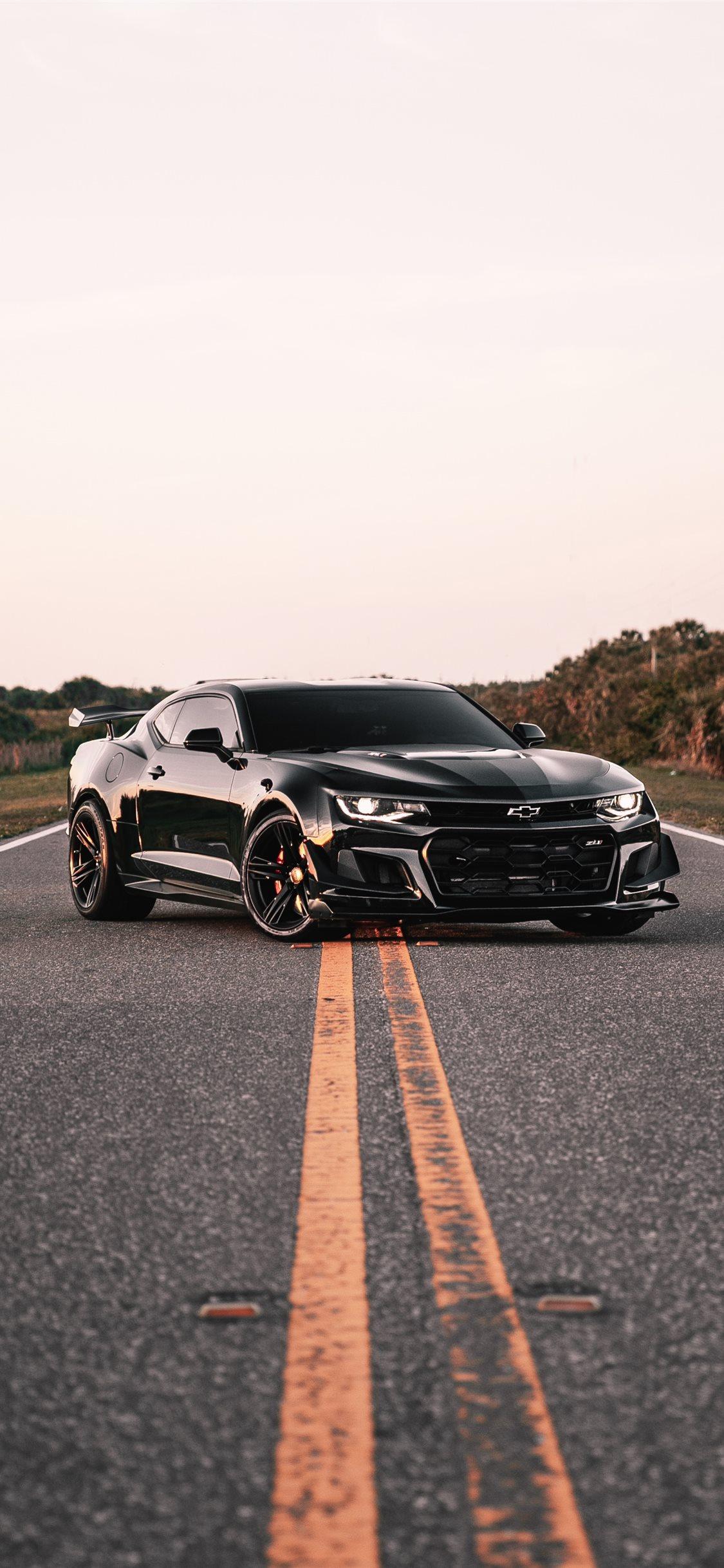 1125x2436 parked black coupe on road iPhone X Wallpaper Free Download