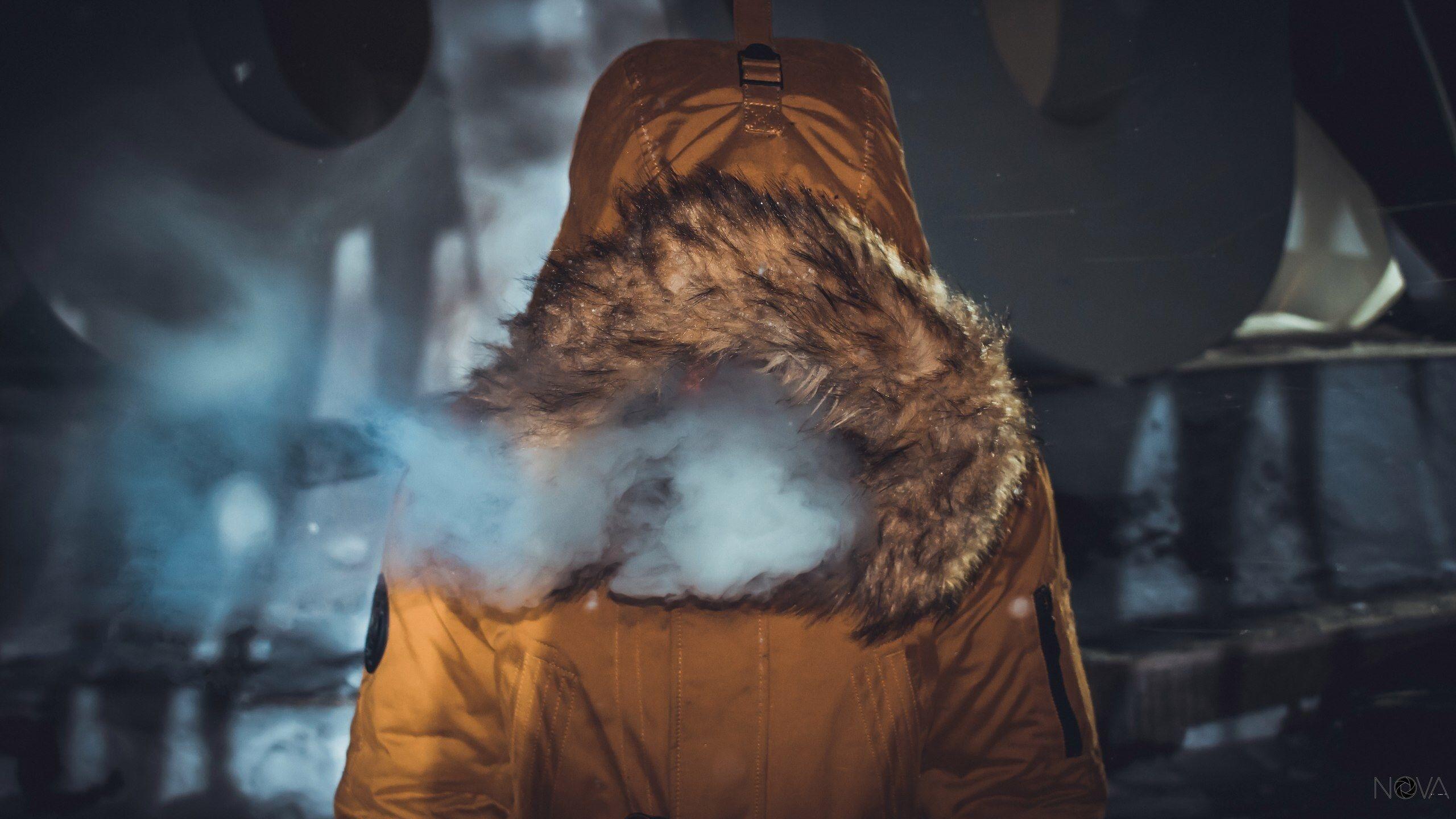 2560x1440 anonymous person in a furry hooded coat exhaling smokecity portrait