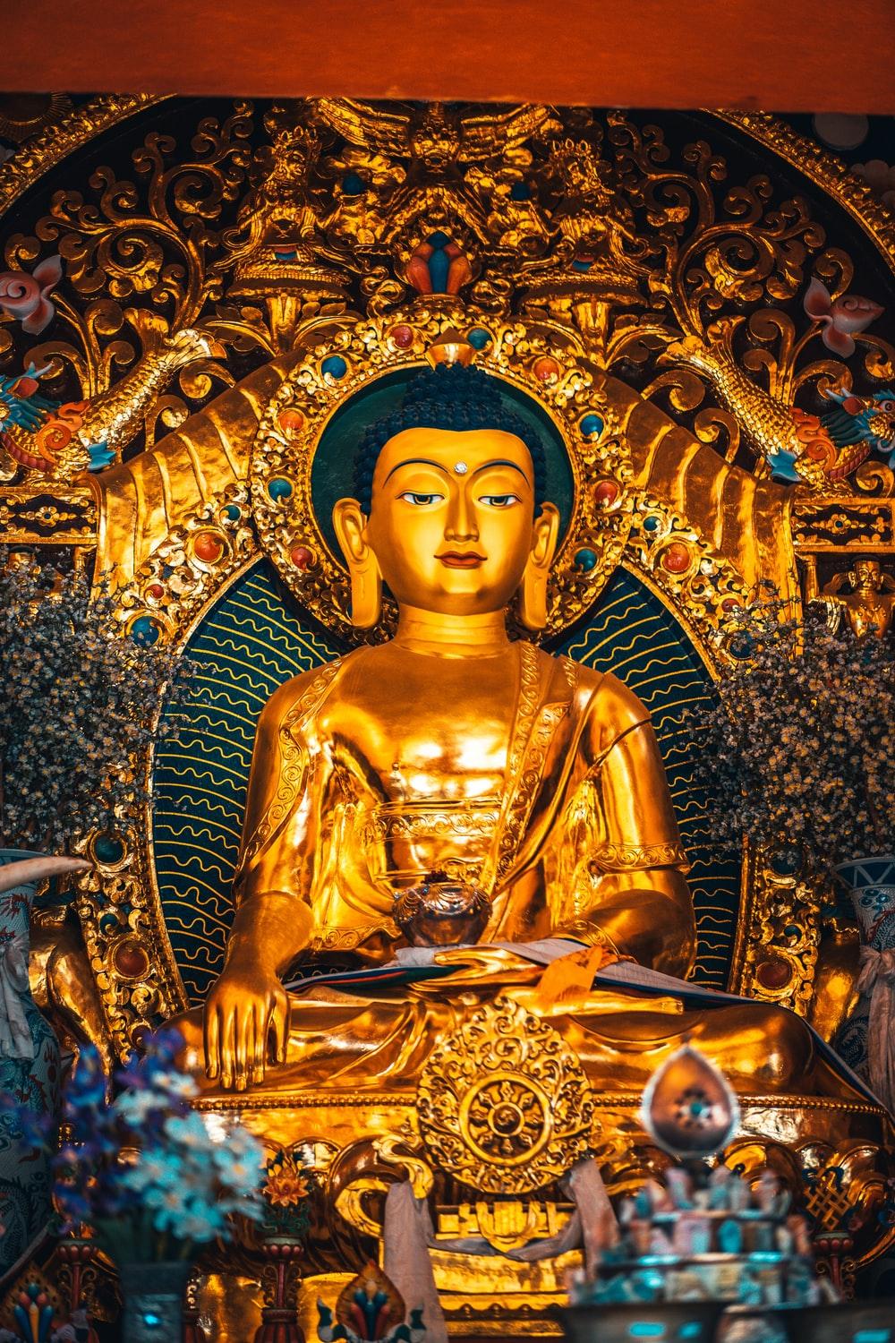 1000x1500 gold buddha statue with blue and gold background photo