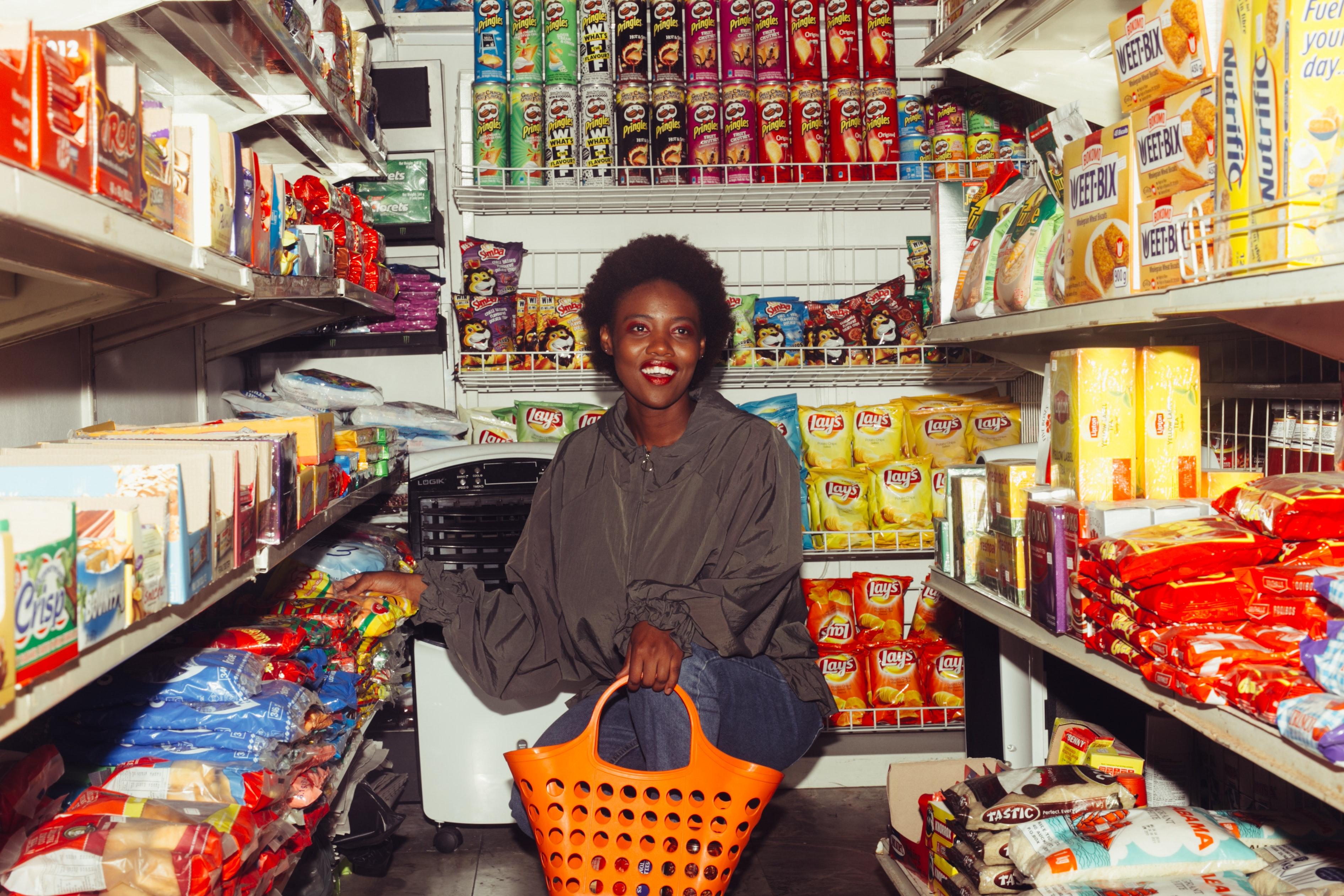 3783x2522 Happy Woman Buying Groceries in a Convenience Store · Free