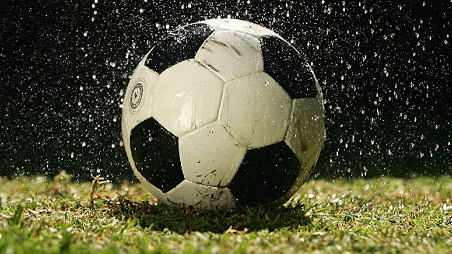 1920x1080 Football In Rain Wallpaper