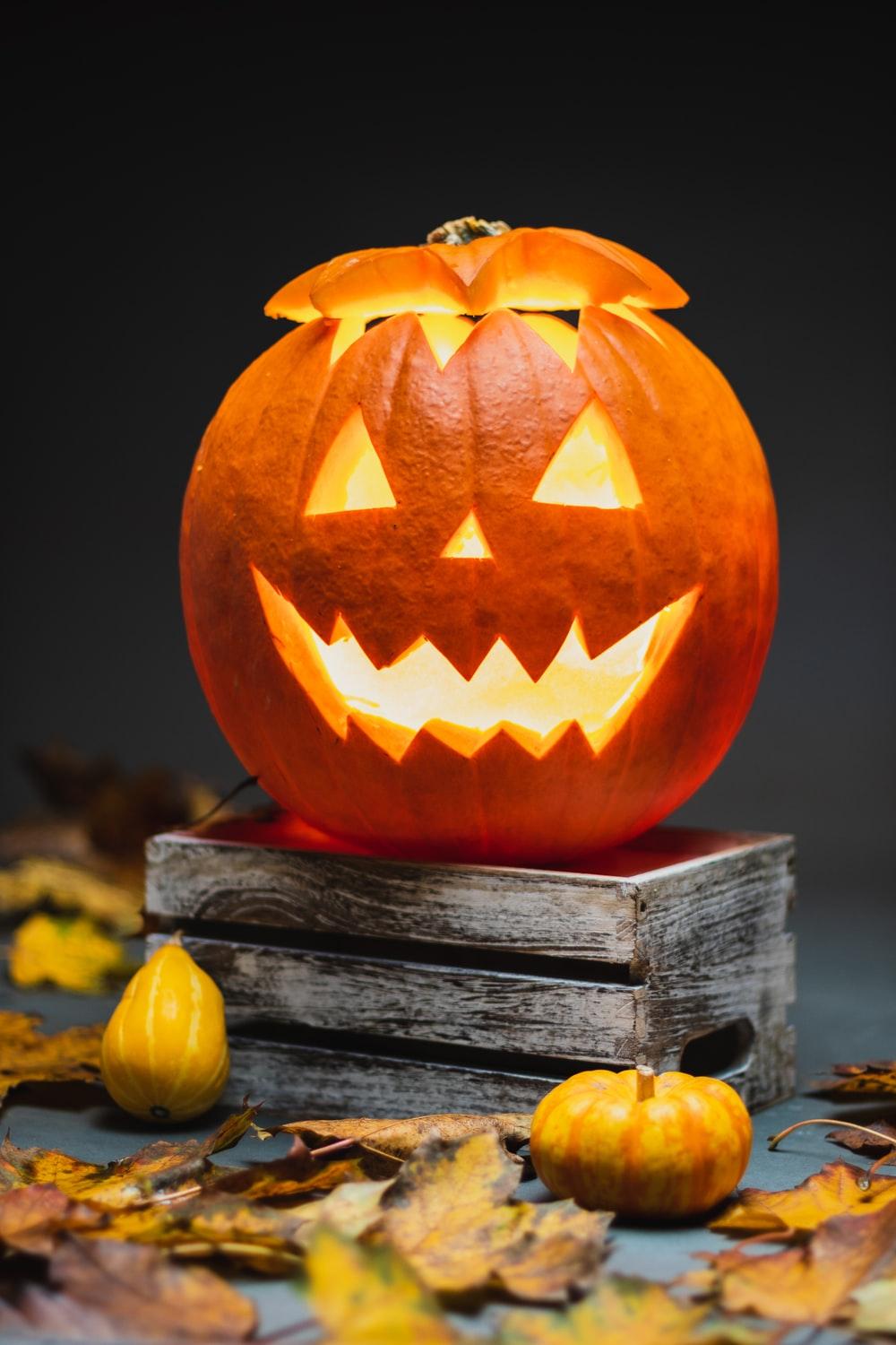 1000x1500 jack o lantern on brown wooden table photo