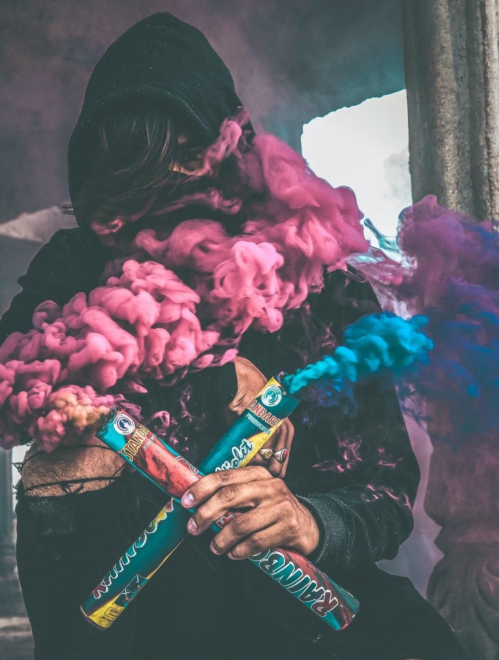1000x1323 person holding colored smoke photo