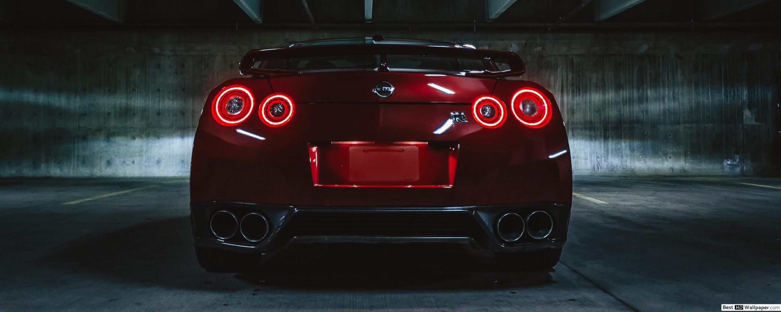 2560x1024 Red Nissan GTR Sports Car On Concrete Flooring HD wallpaper download