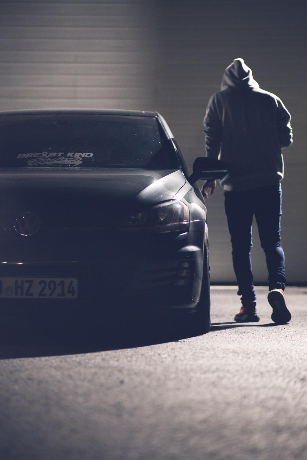 1000x1500 man in black jacket standing beside black car photo