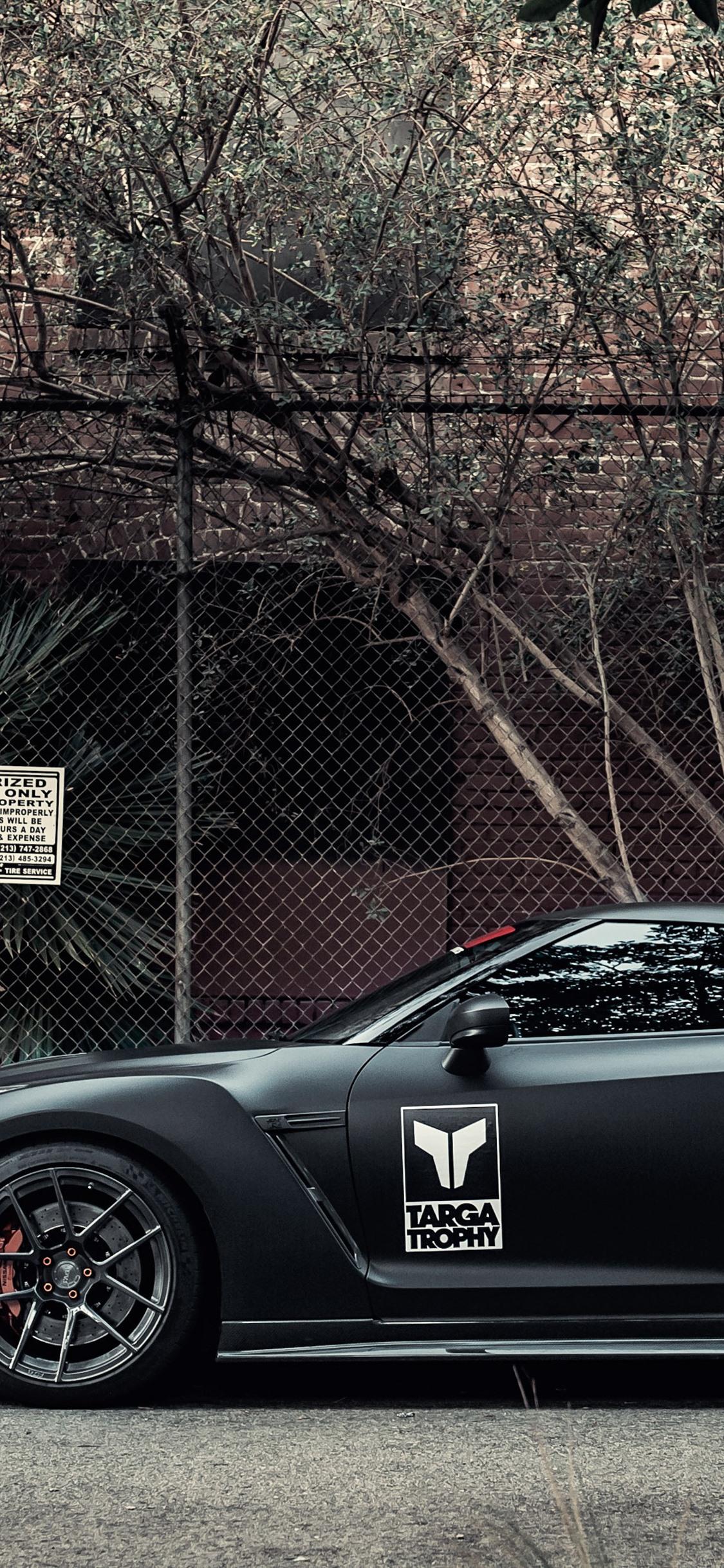 1125x2436 Nissan GT R Black Supercar Side View, Wire Fence 1125x2436 IPhone 11 Pro XS X Wallpaper, Background, Picture, Image