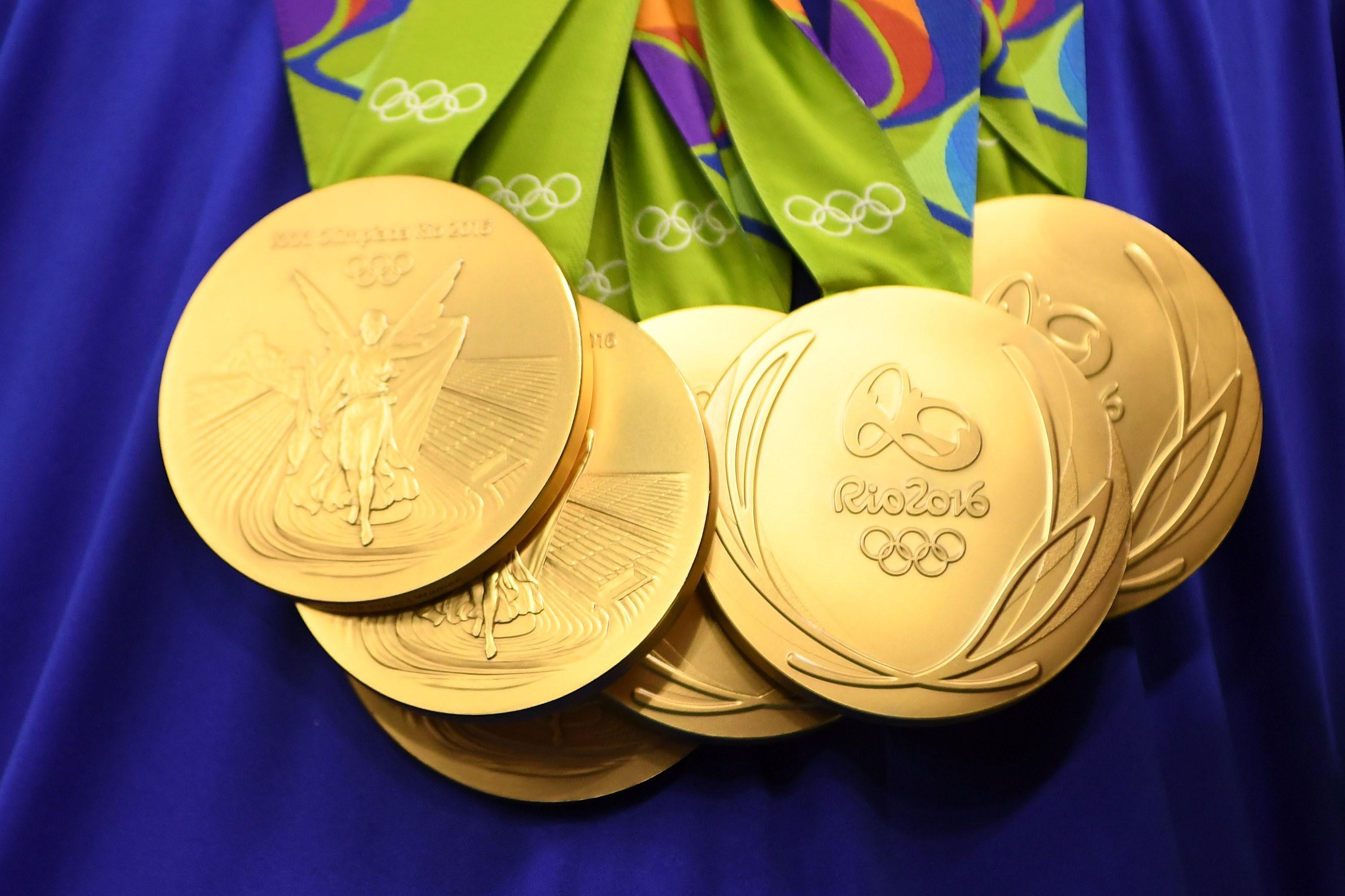 Premium Photo | Hand of woman holding gold medal on yellow background.award  and victory concept.copy space