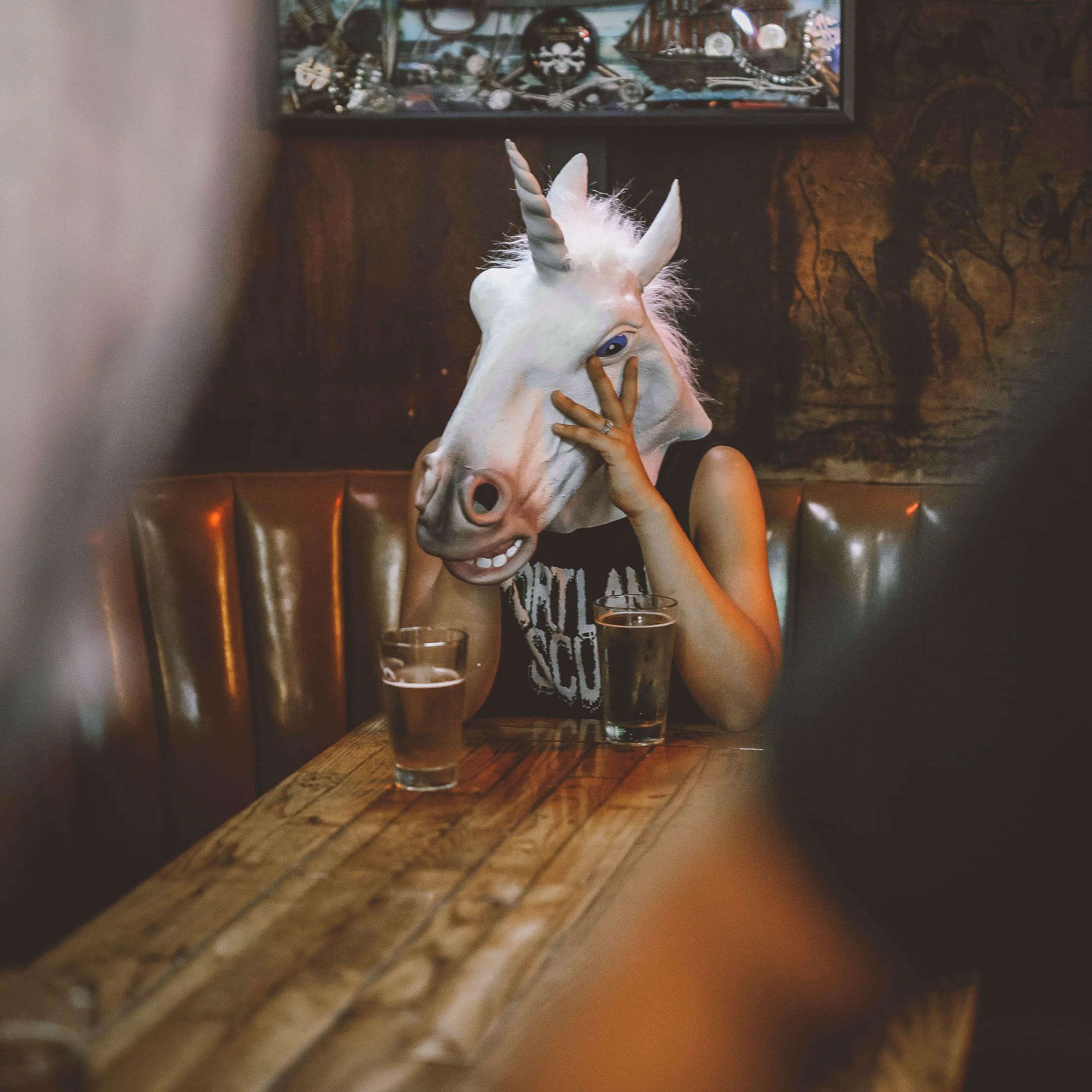 2236x2236 Wallpaper Person With Unicorn Head Sitting Near Table