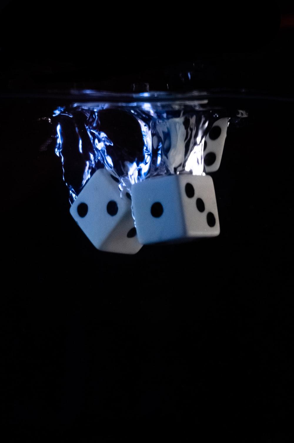 1000x1505 white and black dice in blue and white container photo