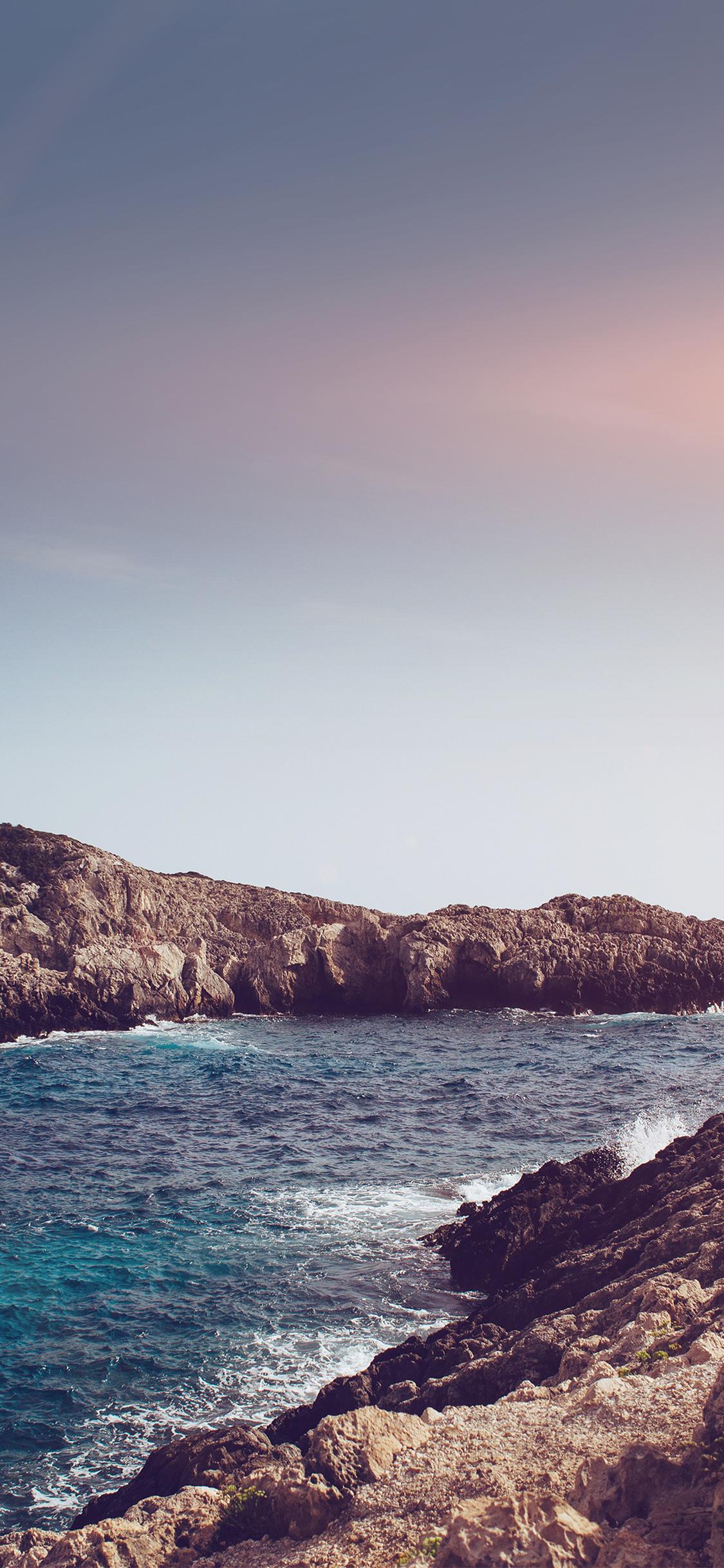 1125x2436 one sunny day beach rock sea nature flare