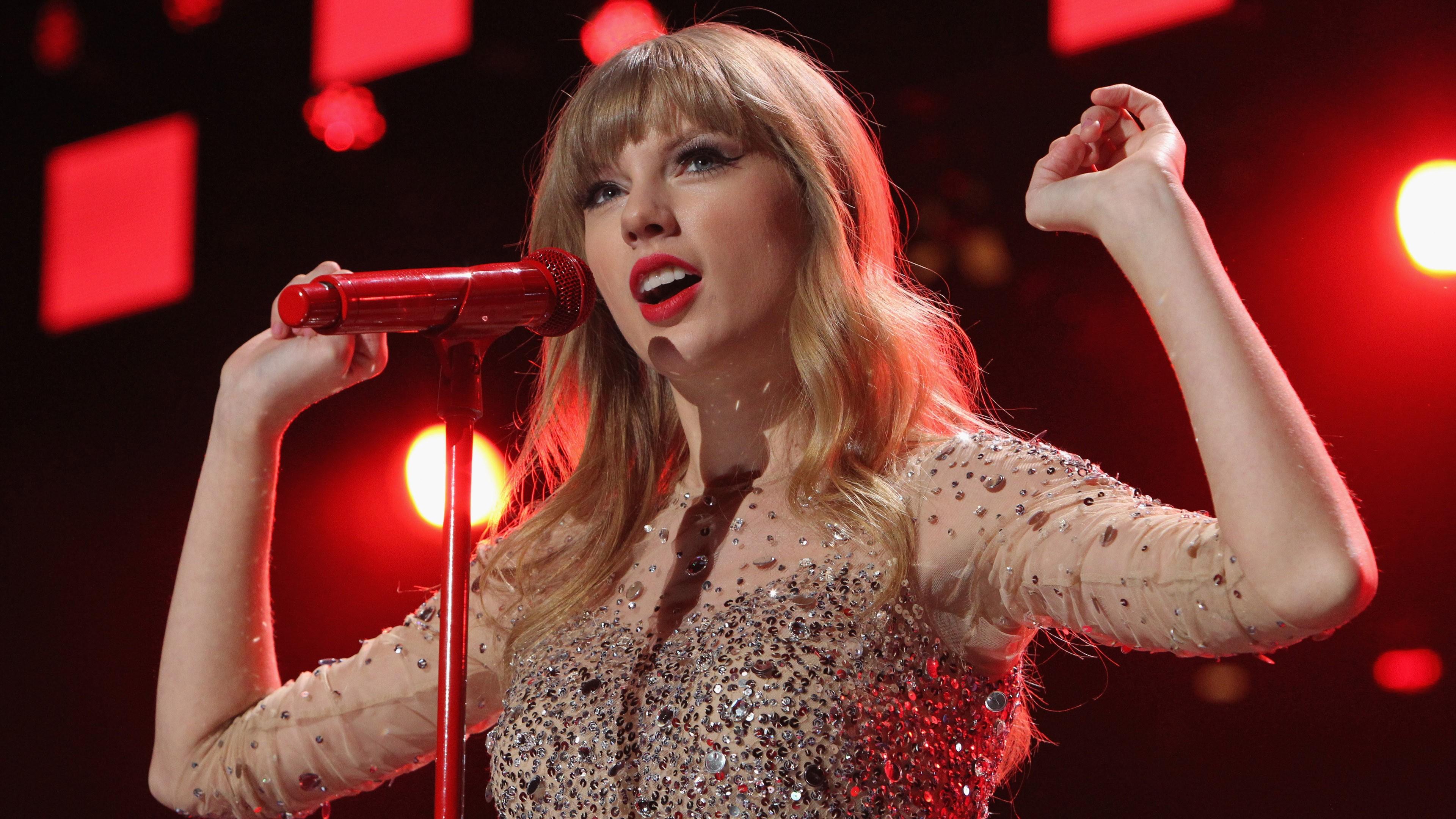 3840x2160 Taylor Swift In Red Lightning Background Wearing Glittering Dress Singing 4K HD Celebrities Wallpaper