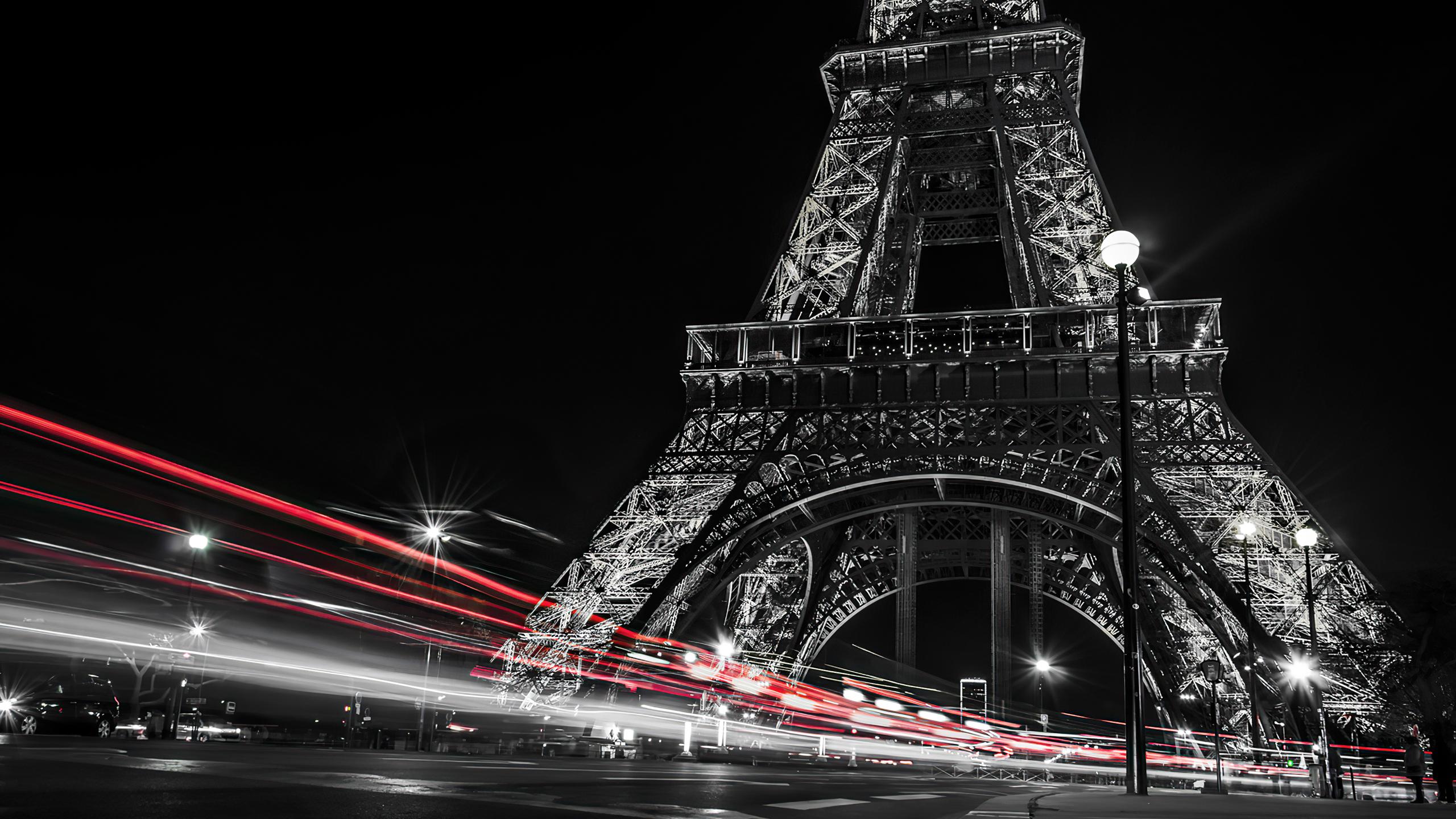 2560x1440 Black And White Picture Of Paris Eiffel Tower And Red Lights On Road With Dark Sky Background During Night HD Travel Wallpaper