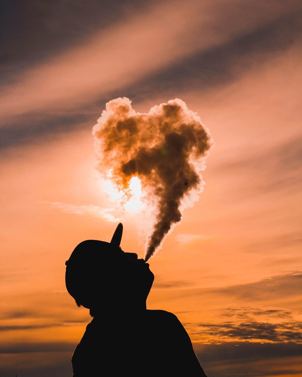 1000x1250 man doing vape tricks photo