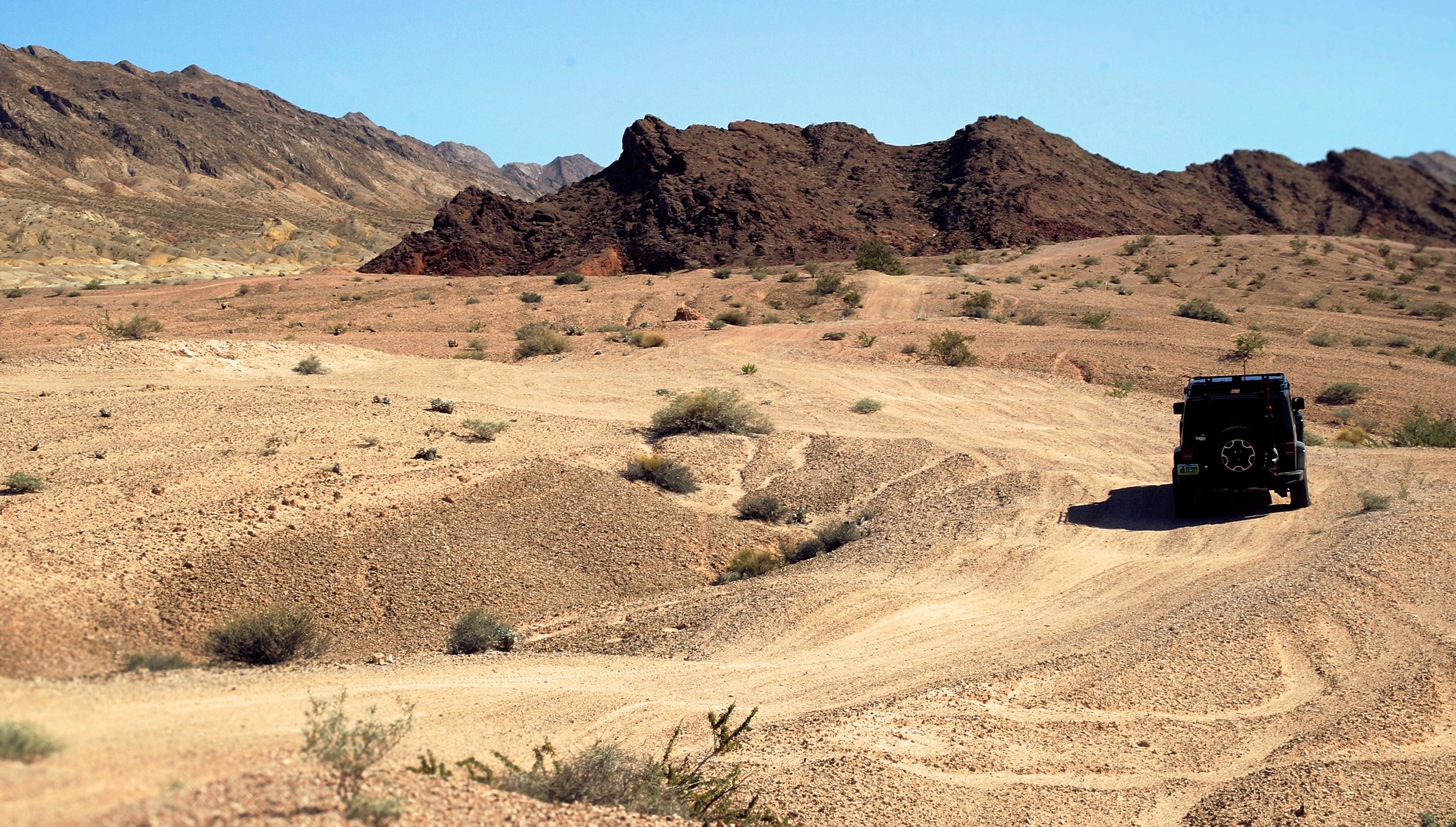 3568x2027 Wallpaper / jeep truck drives through rough terrain of the desert in las vegas, black jeep desert vegas 4k wallpaper