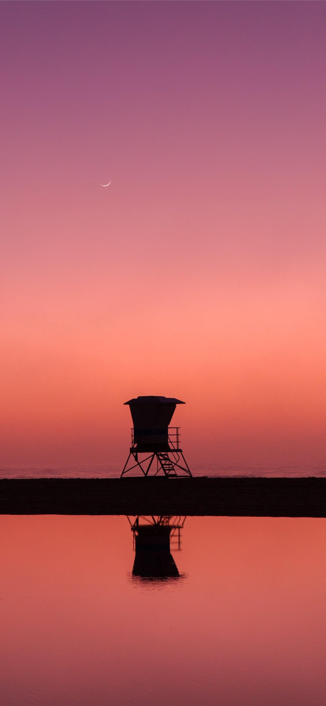 1125x2436 silhouette photo of lifeguard house iPhone X Wallpaper Free Download