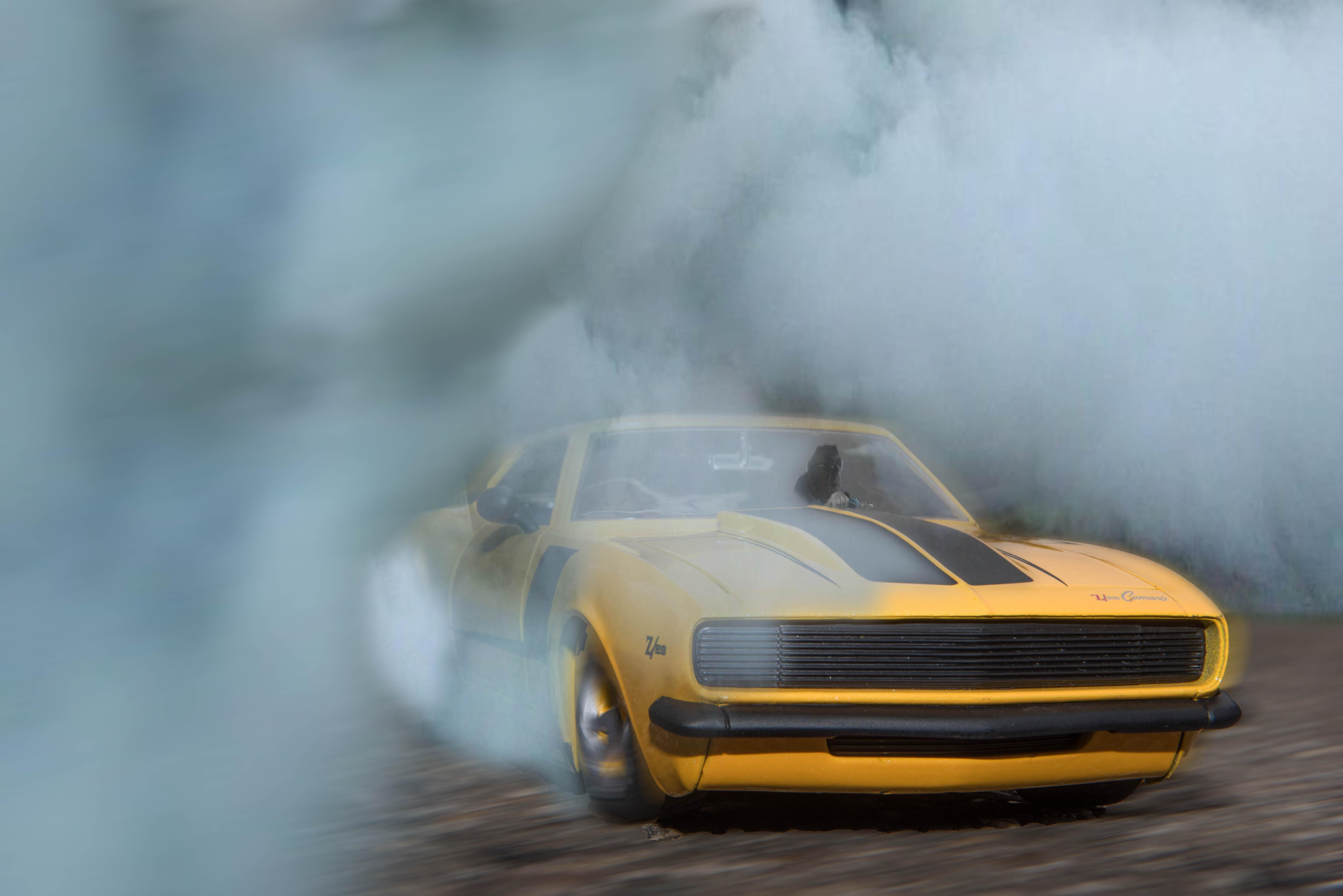 6016x4016 Classic Yellow And Black Sports Car Drifting On Road With Smoke · Free