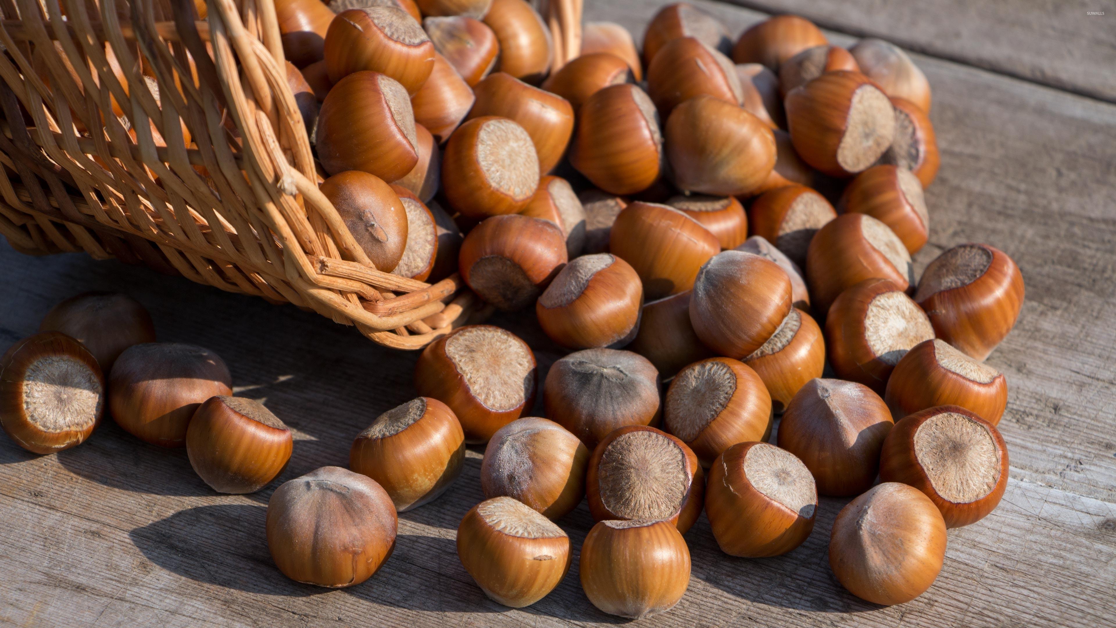 3840x2160 Hazelnuts spilled on an old table wallpaper wallpaper