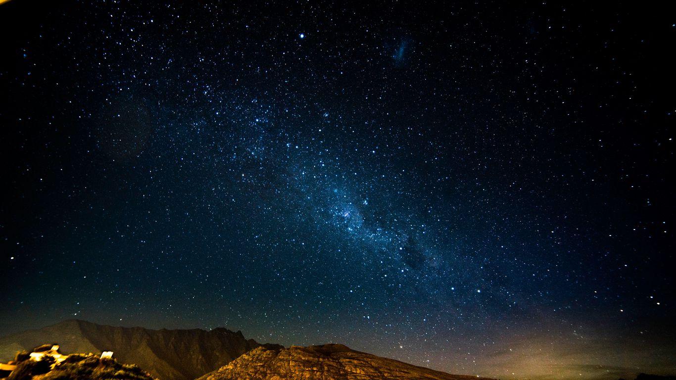 1366x768 Download wallpaper 1366x768 starry sky, night, mountains, radiance, glitter tablet, laptop HD background