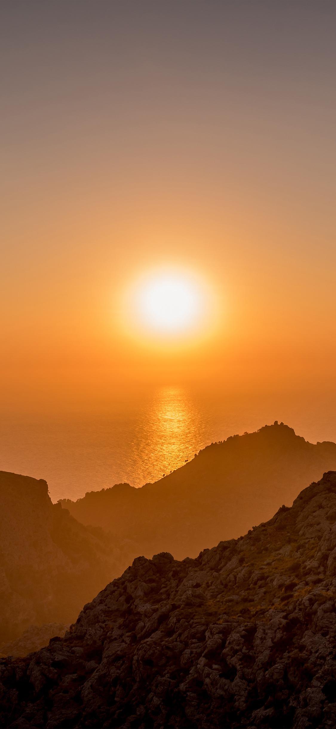 1125x2436 iPhone X wallpaper. sea sunset afternoon rock mountain orange