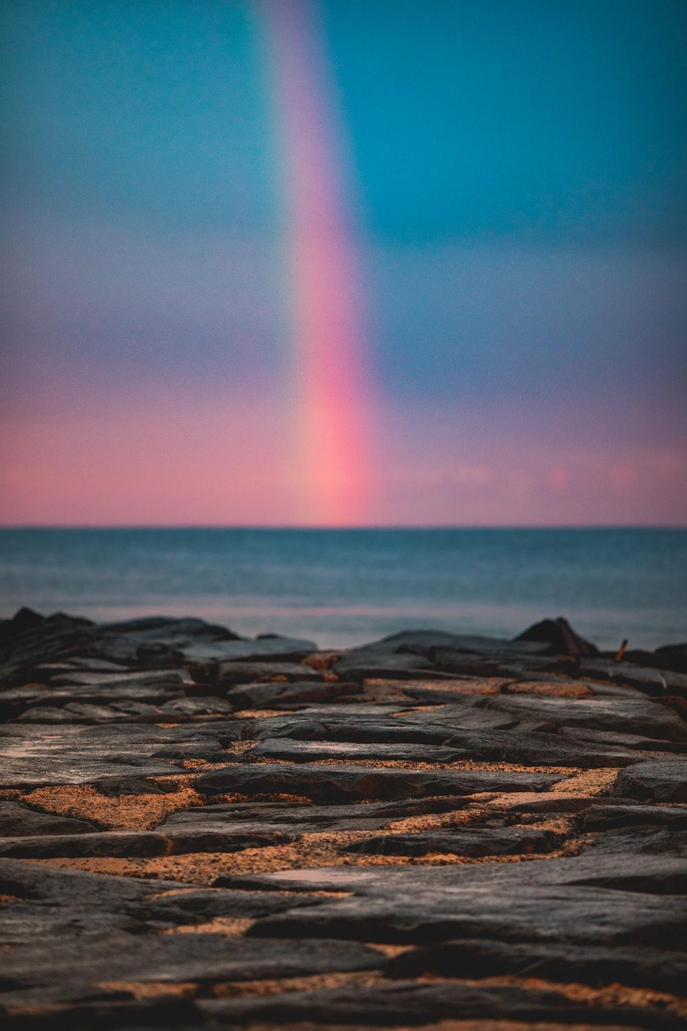 1000x1500 rainbow at sea during sunset photo