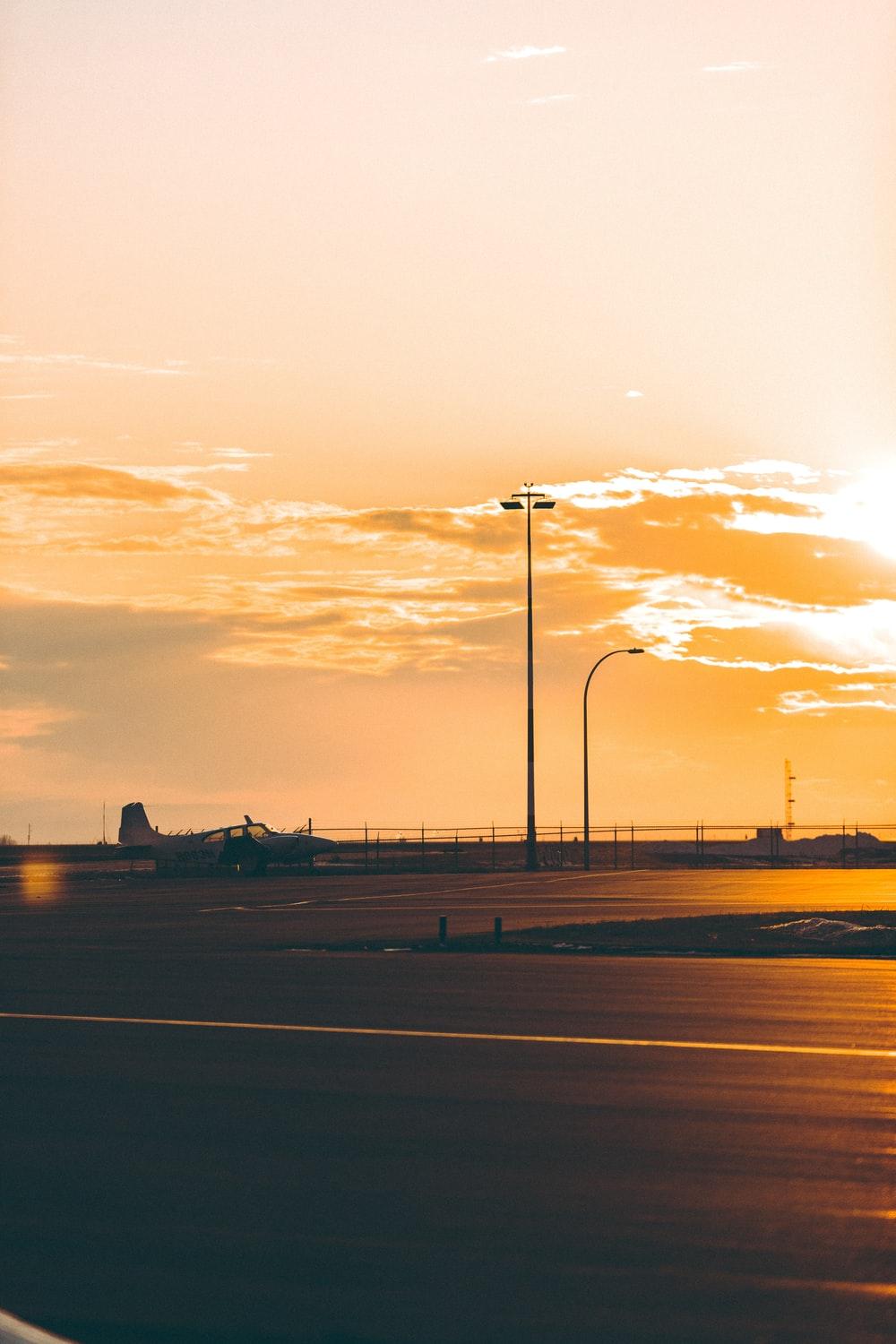 1000x1500 silhouette of airplane on airport during sunset photo
