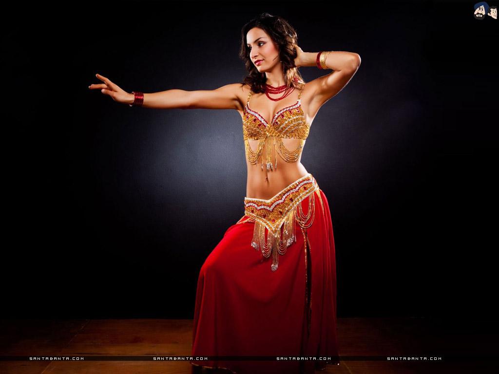 1024x768 A beautiful belly dancer posing with a dance move