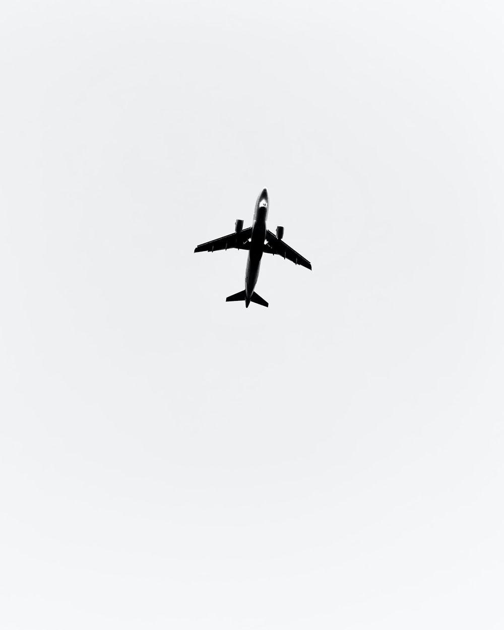 1000x1250 black airplane in mid air photo