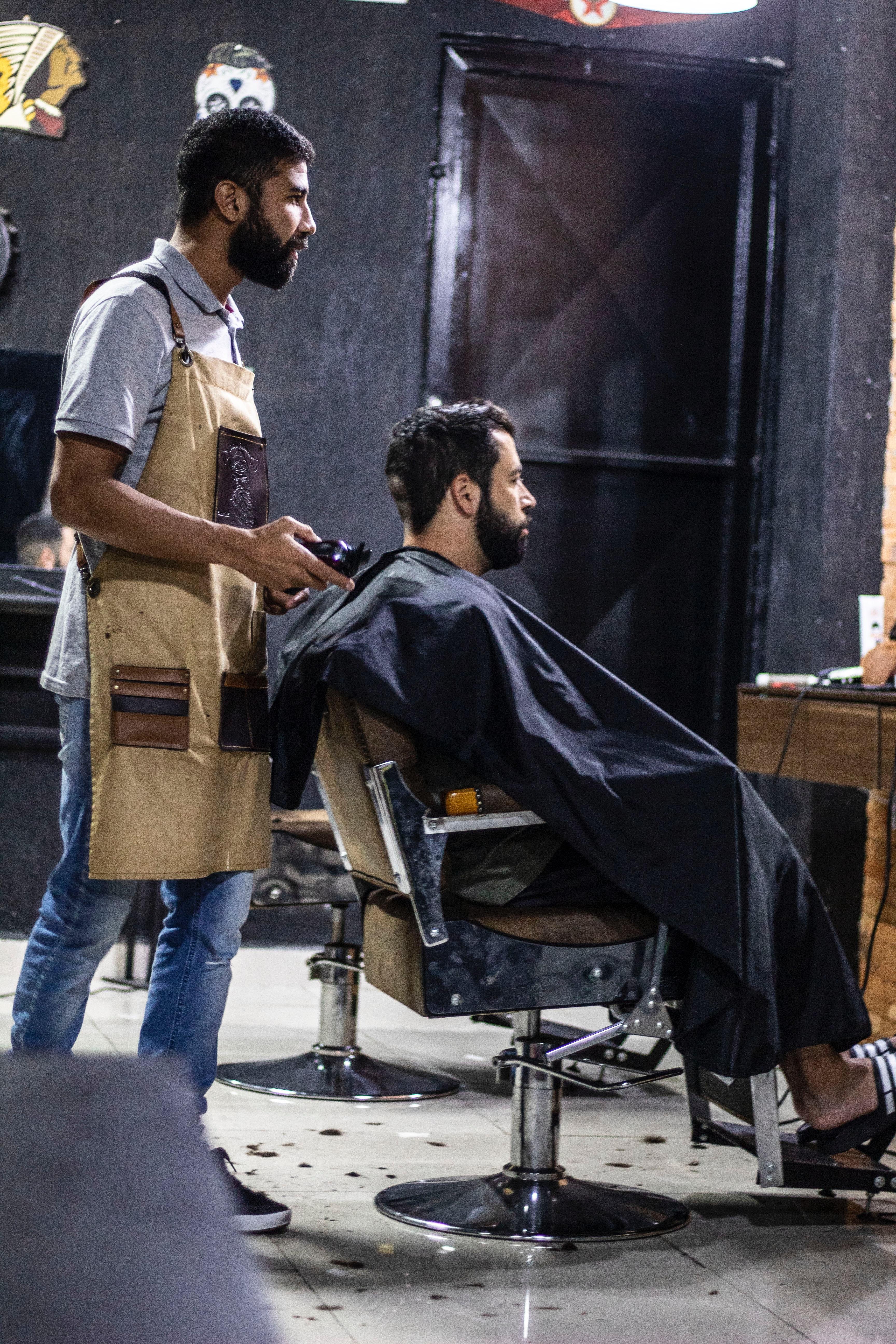 3456x5184 Man Wearing Brown Apron and Man Sitting on Gray Stainless Steel Barber's Chair · Free