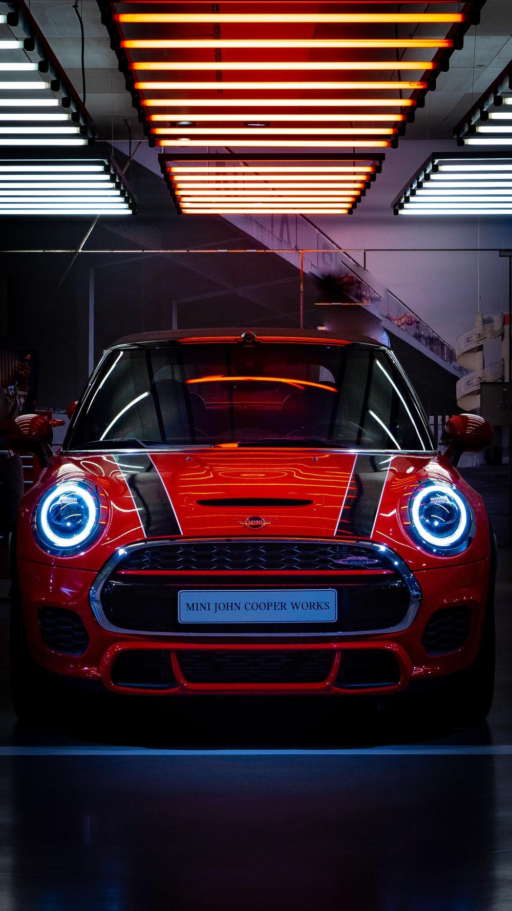 1000x1778 red and black vehicle inside black and white room photo